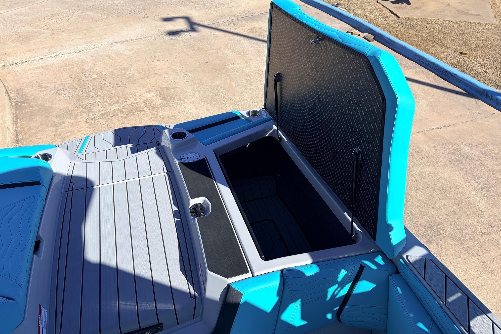 2026 Nautique Super Air Nautique G23 boat with open storage compartment, showcasing sleek design.