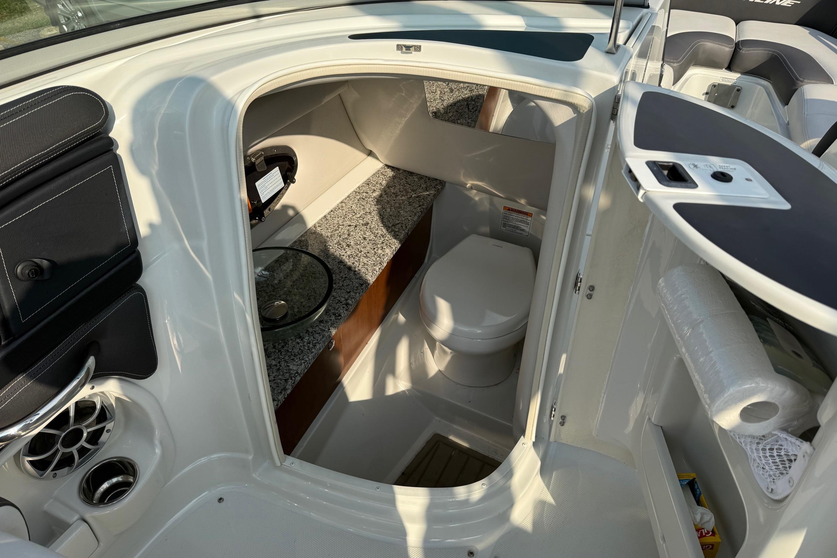 2023 Crownline 260 SS boat interior with compact bathroom and modern amenities.