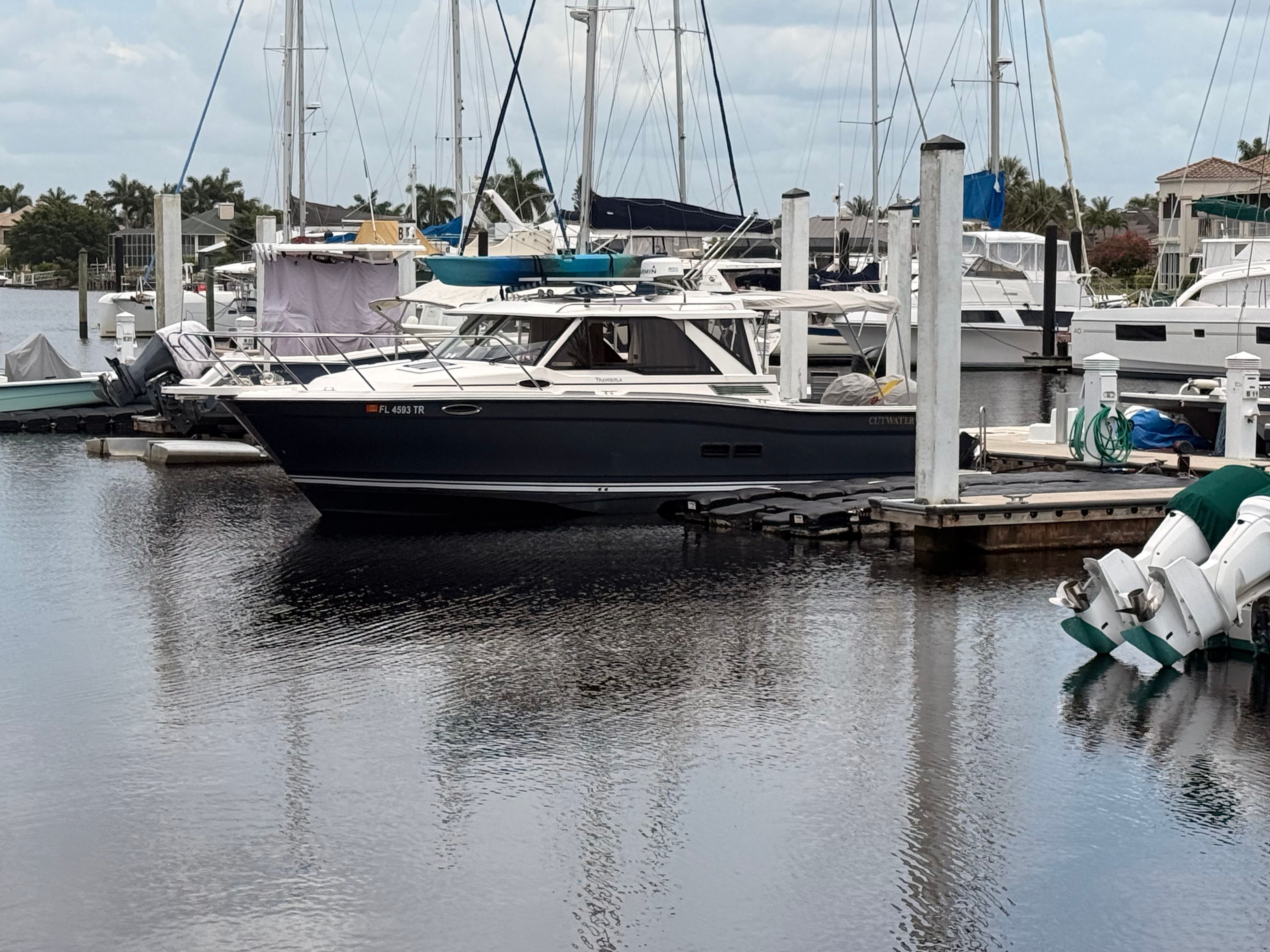 A 2023 Cutwater C-228 docked at a calm marina.