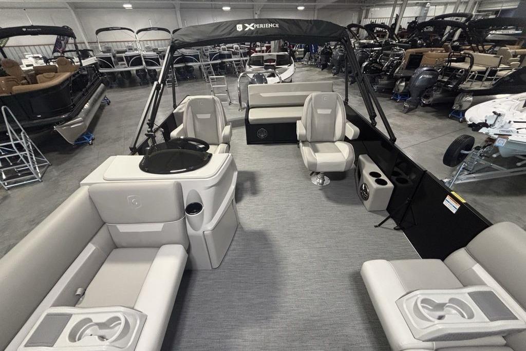 2026 Godfrey Xperience 2086 SFLX pontoon boat interior with seating and helm in showroom.