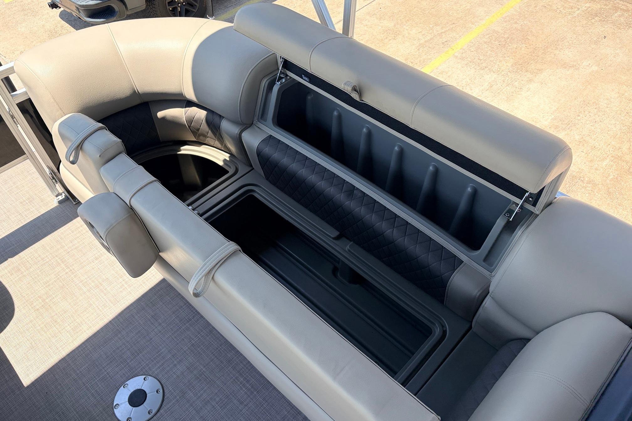 2024 Sun Tracker SportFish 22 XP3 boat seating with open storage compartment.