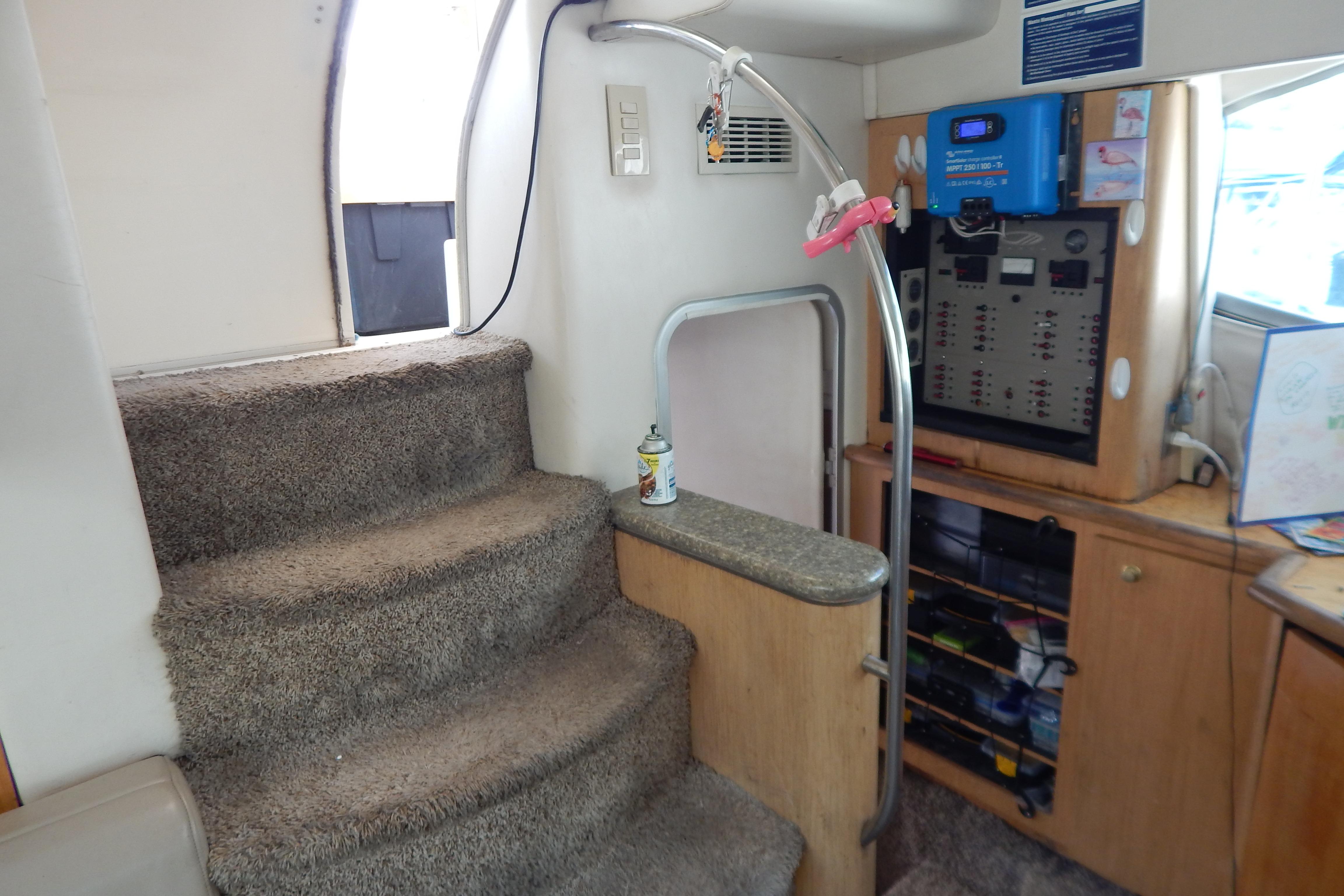 Interior of a 1998 Magnum 4100 SCR yacht with carpeted stairs and control panel.