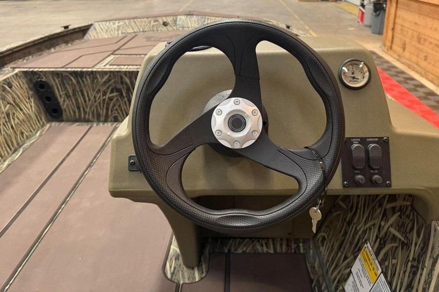 Steering wheel of 2026 Tracker Grizzly 1754 SC All-Welded boat, featuring camo interior design.