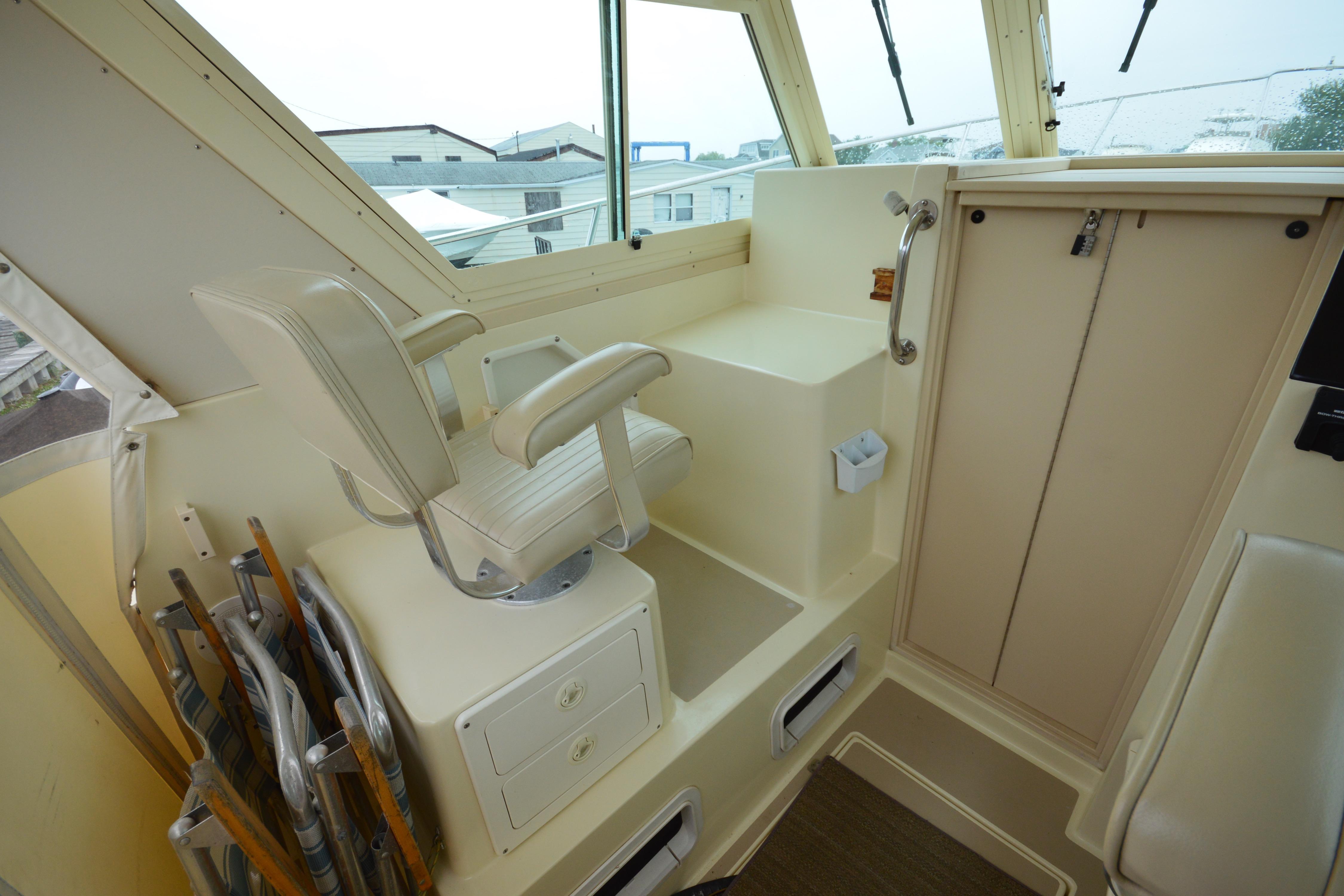 Interior of 2001 Albin 28 Tournament Express boat with captain's chair and storage.