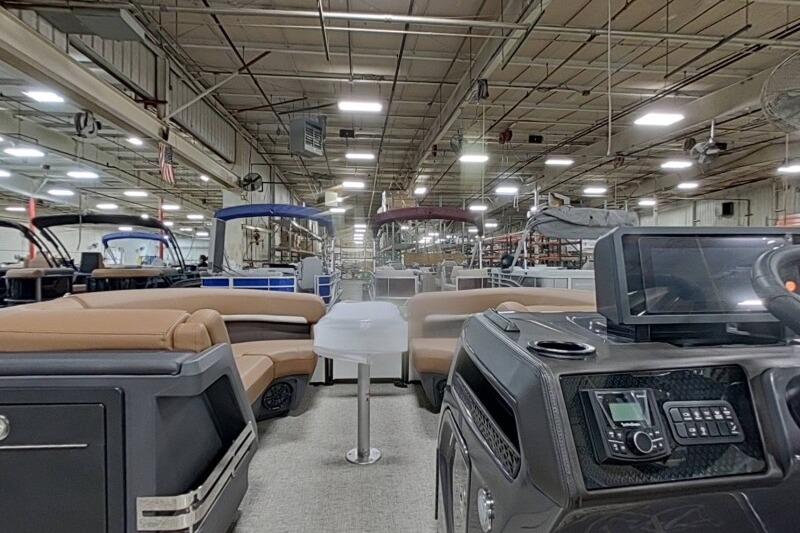 Interior view of a 2026 Bennington 22 MSBSF pontoon boat in a factory setting.