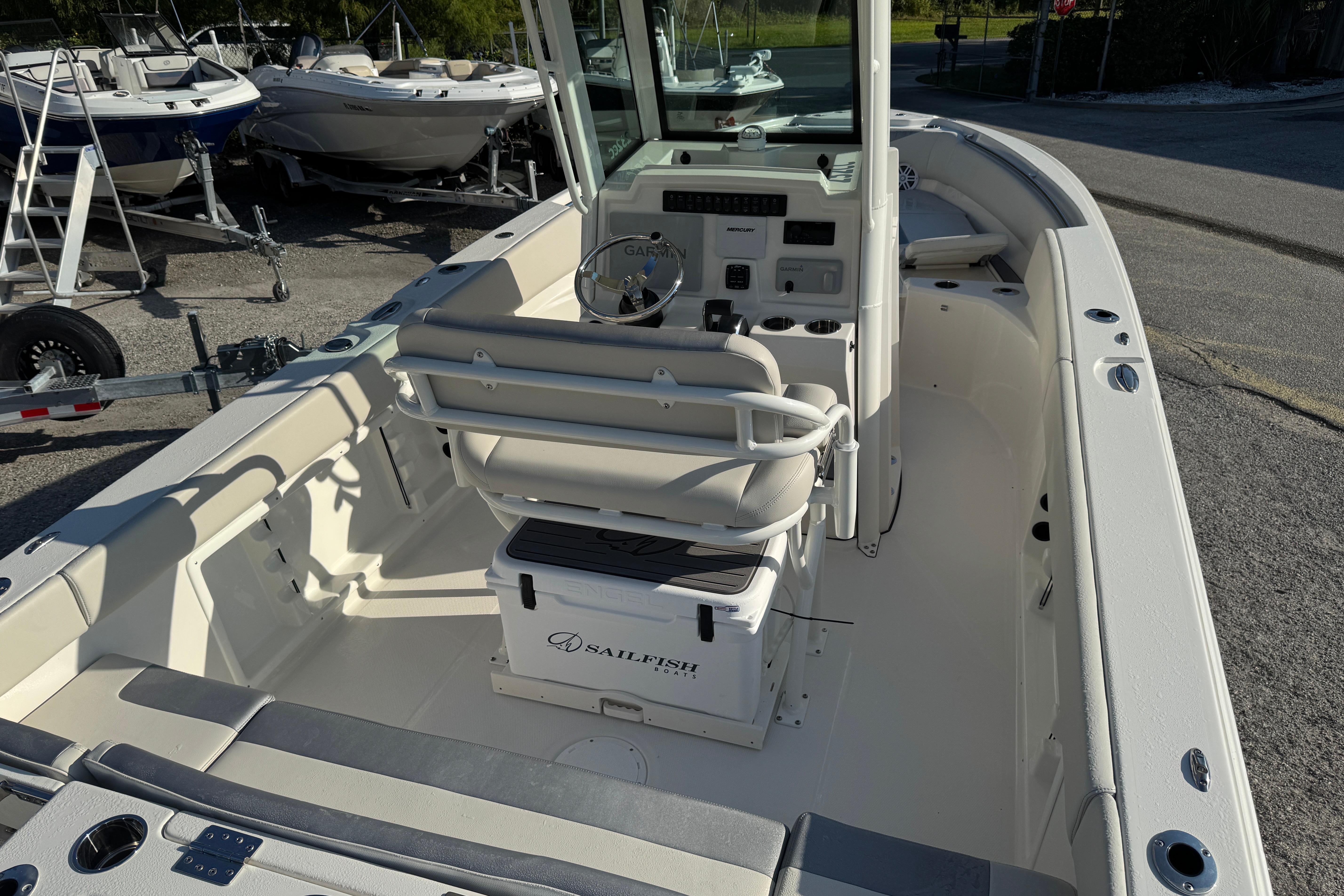 2026 Sailfish 232 CC boat interior with helm, seating, and storage.