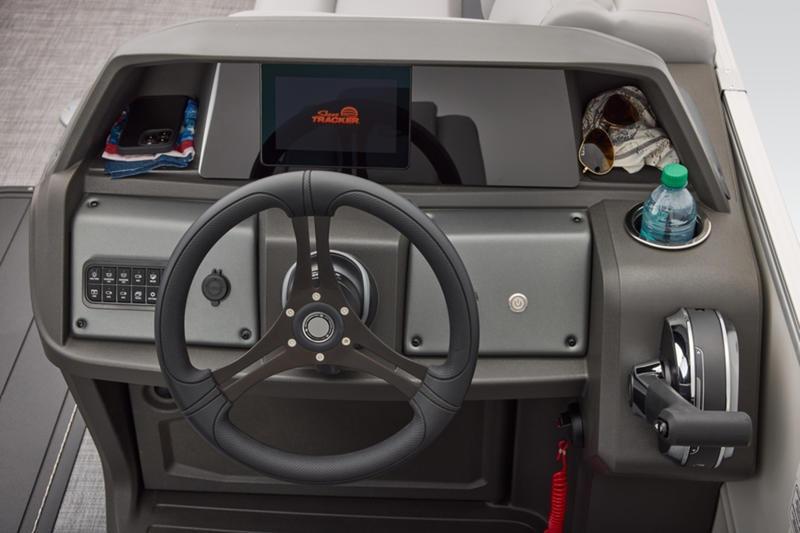 2026 Sun Tracker Party Barge 22 DLX helm with steering wheel, controls, and storage compartments.