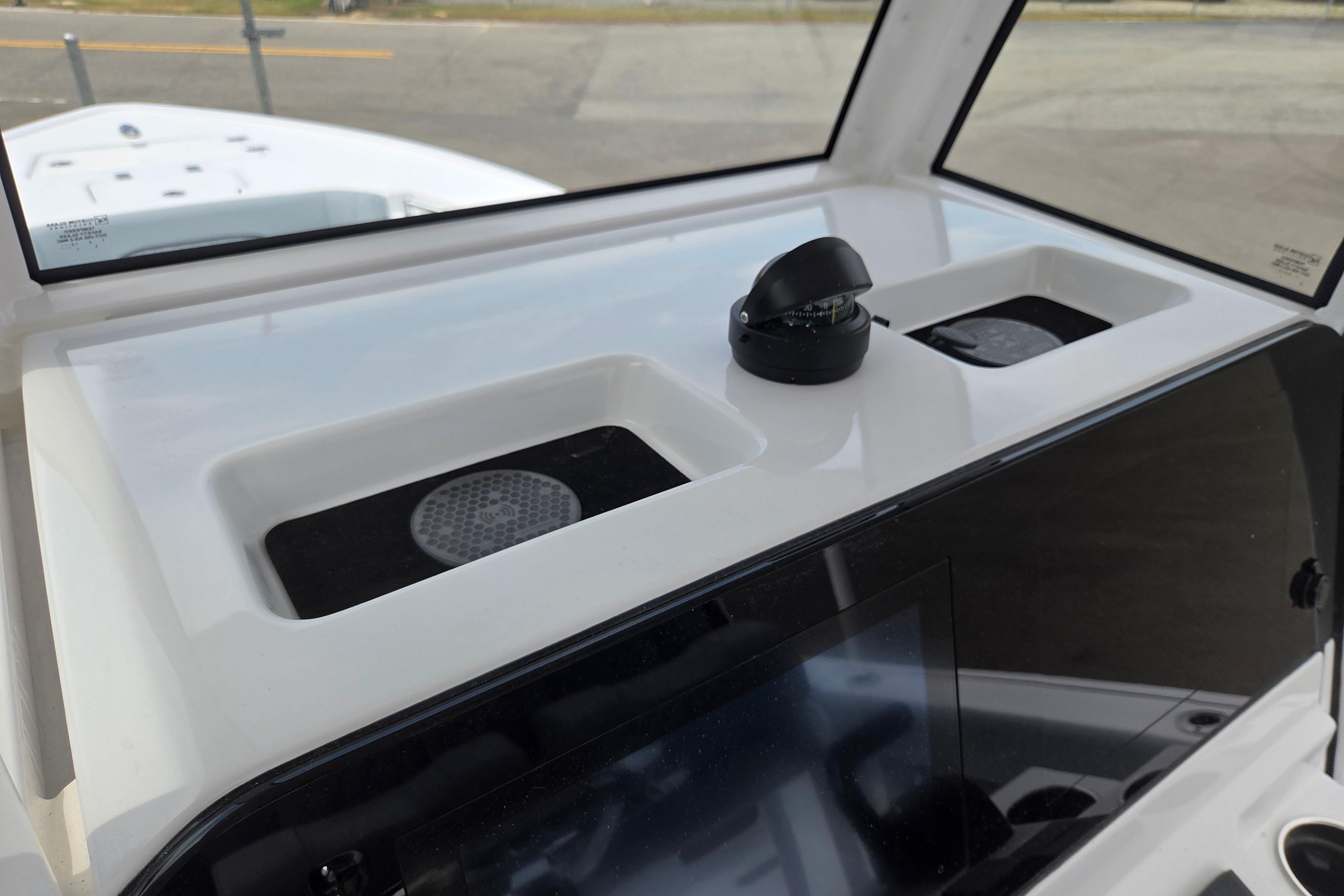 2026 Sportsman Masters 247OE Bay Boat dashboard with compass and storage compartments.