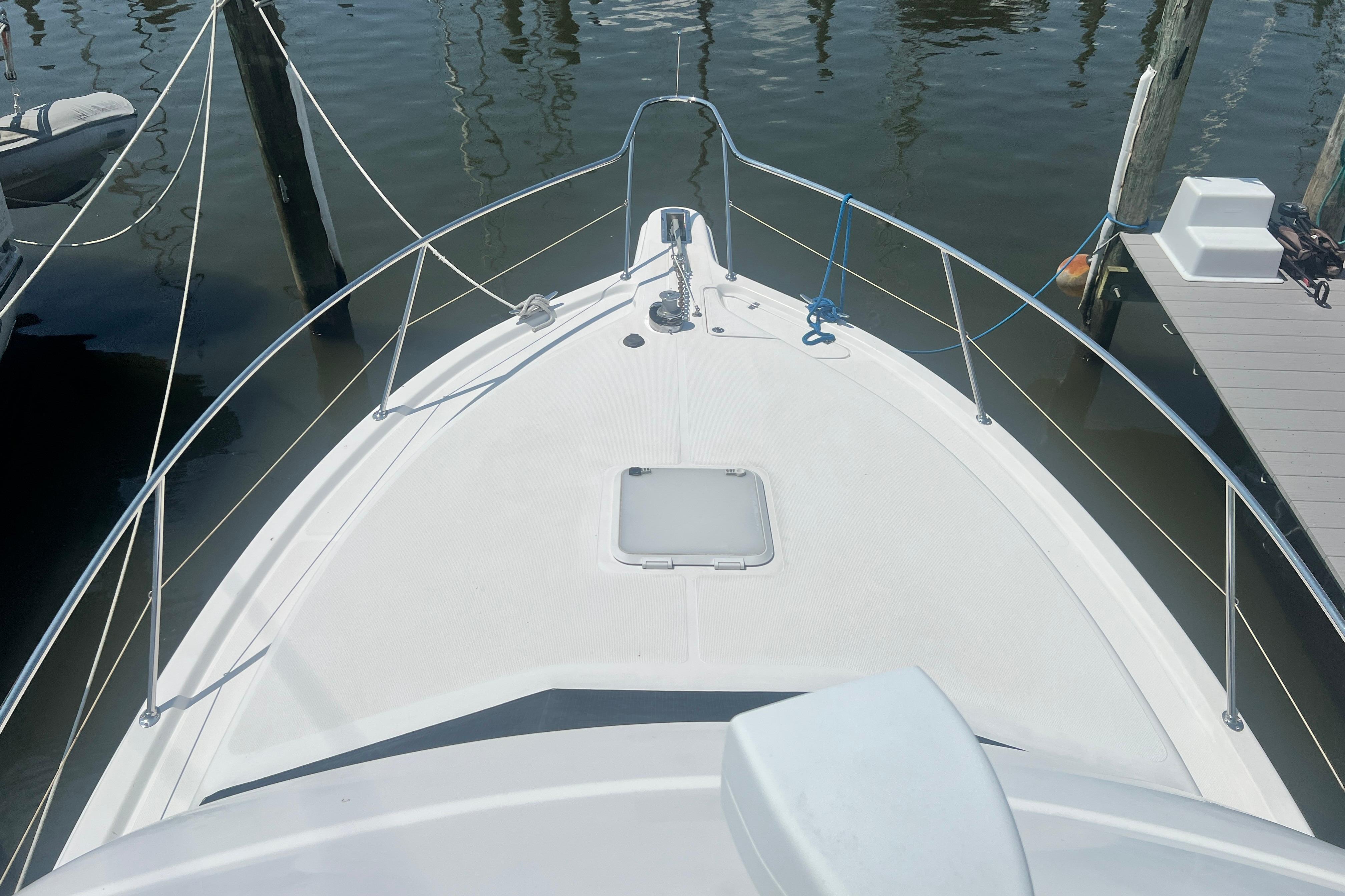 Bow view of 2007 Riviera 33 Flybridge yacht docked at marina.
