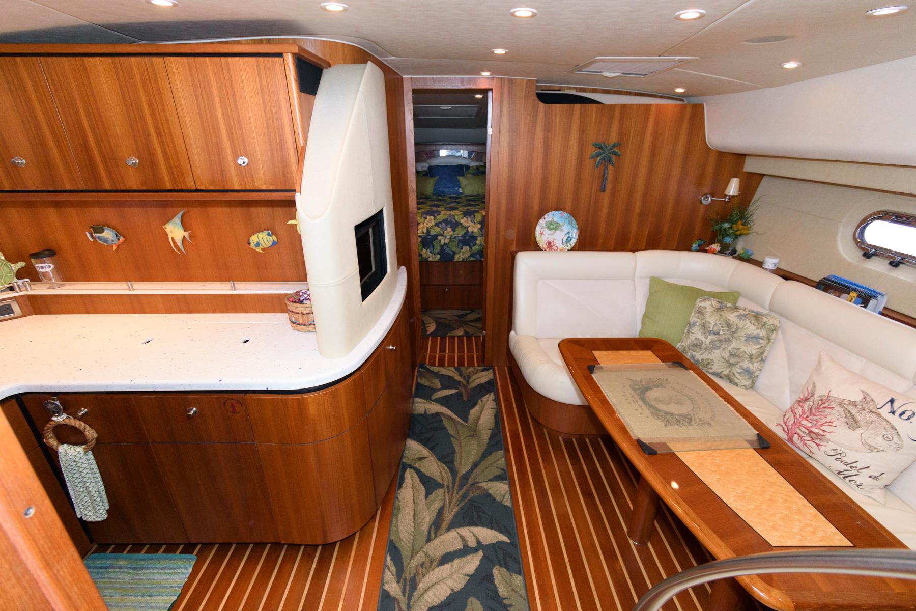 Luxurious 2006 Tiara Yachts 4300 Sovran interior with elegant wood finishes and cozy seating.
