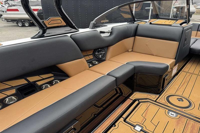 2026 Moomba Tykon boat interior with luxurious tan and black seating.