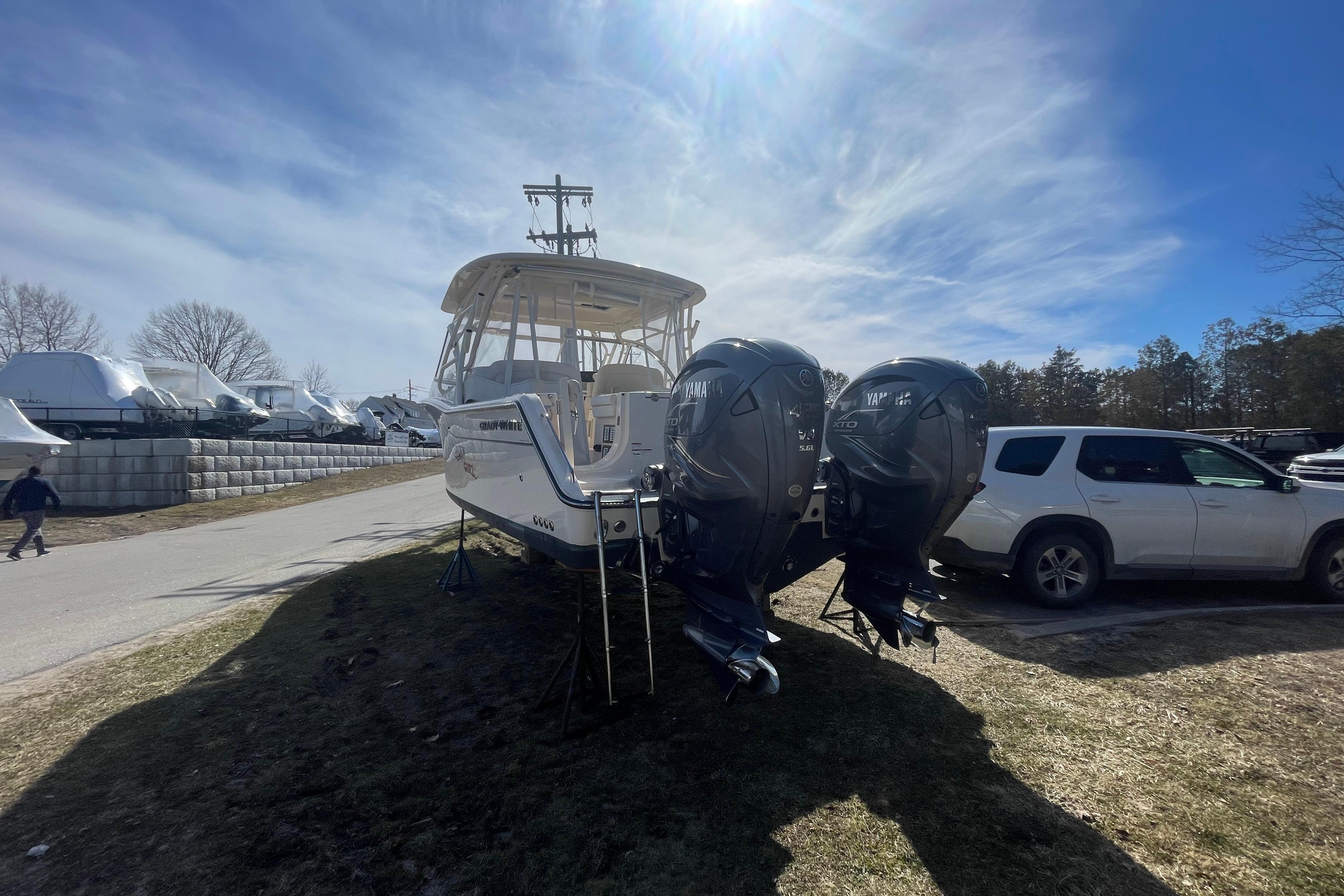 2023 Grady-White Freedom 335 boat with dual Yamaha engines on display outdoors.