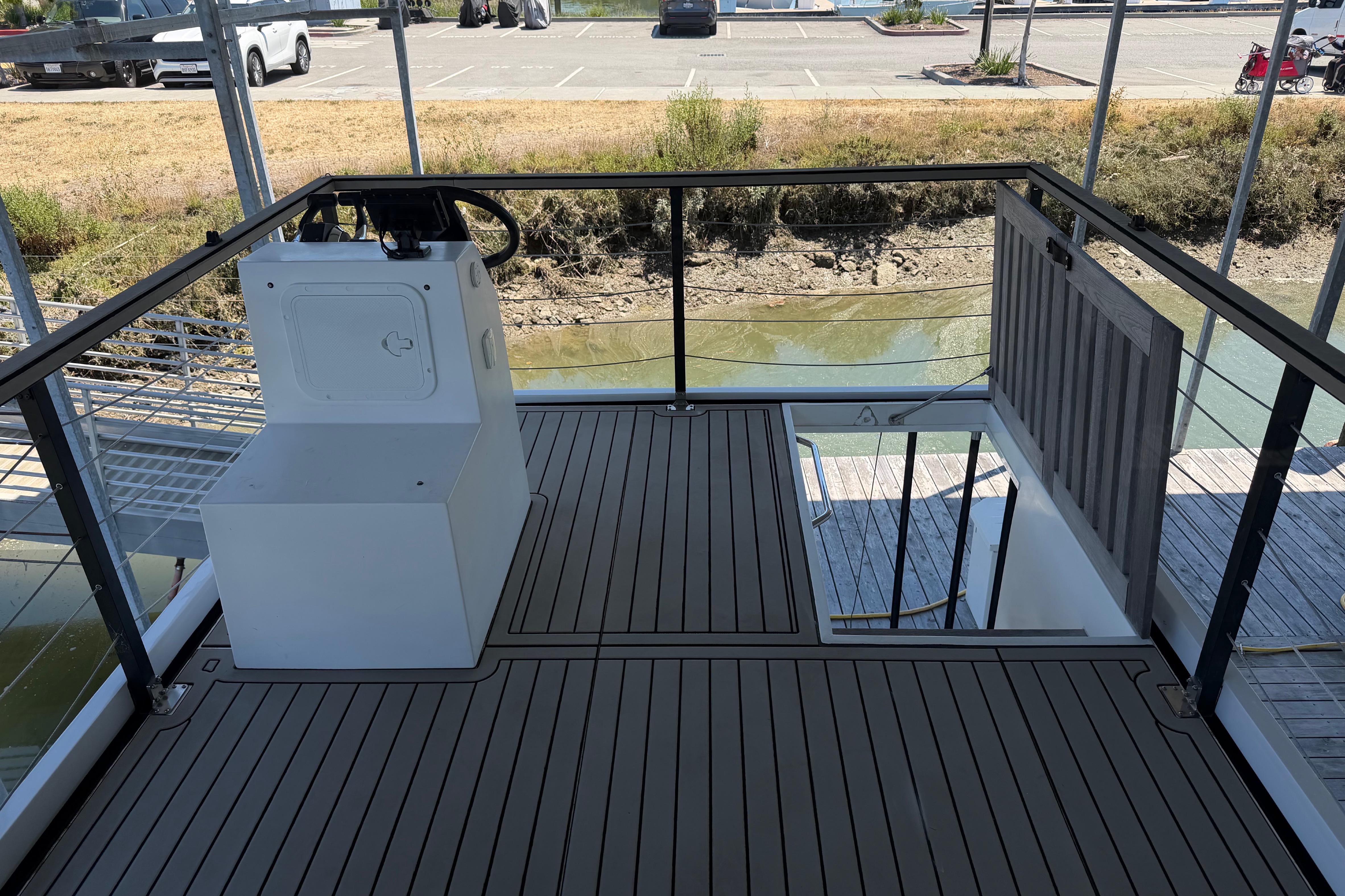 Upper deck of 2022 Navisyo NV.08 boat with steering console and railing.