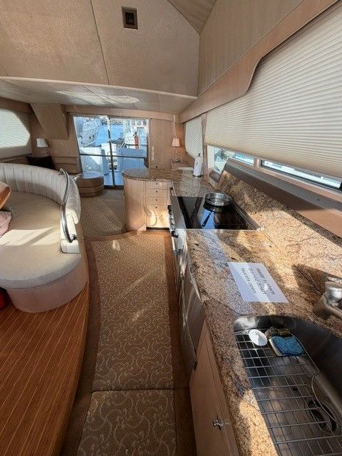 Interior of a 1990 custom motor yacht with kitchen and seating area.