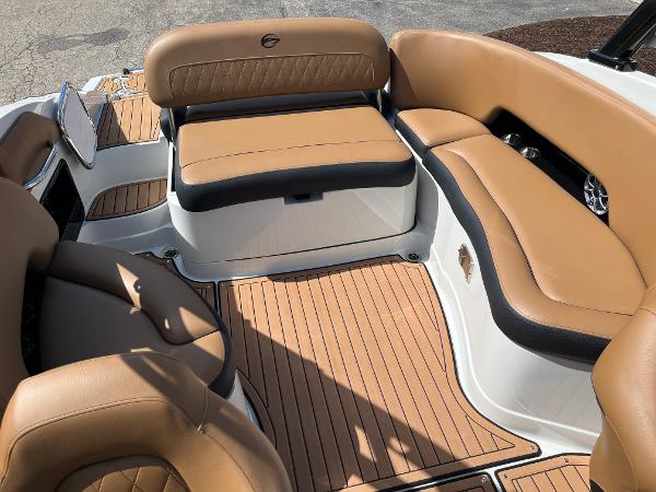 2024 Crownline Eclipse E255 boat interior with tan leather seating and wood-style flooring.