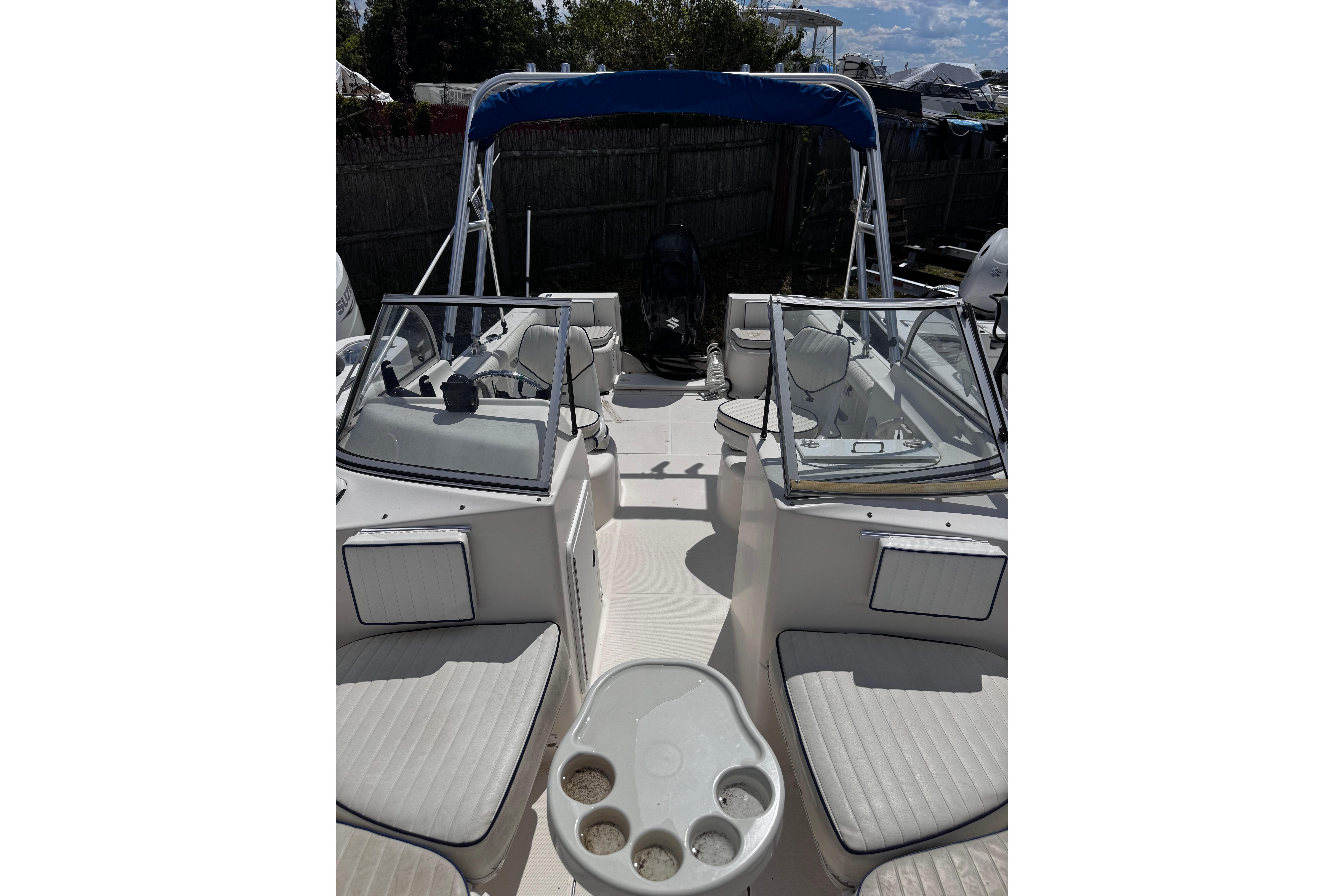 2003 Palm Beach 2200 Dual Console boat interior with seating and windshield.