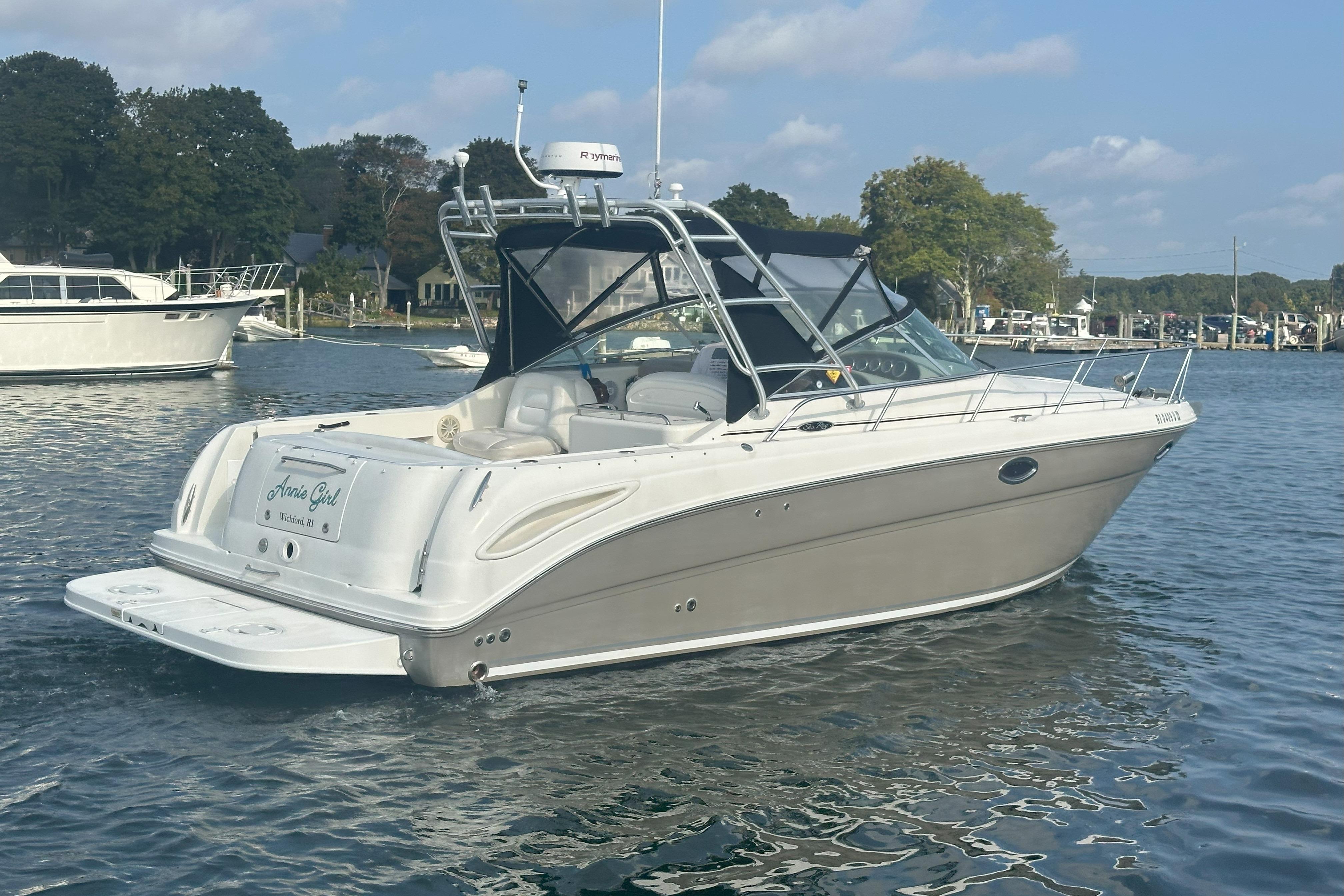 2006 Sea Ray 290 Amberjack boat on calm water, featuring sleek design and spacious deck.