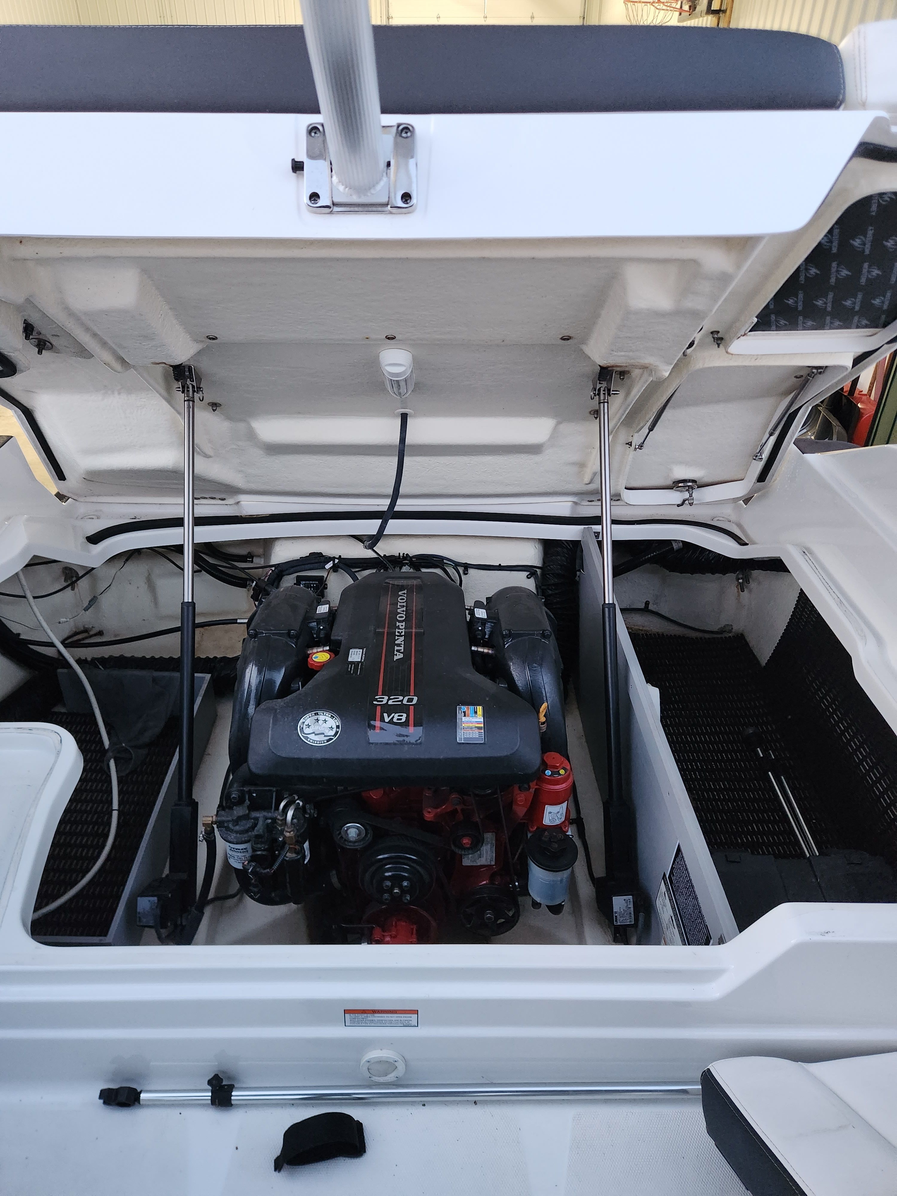 Engine compartment of a 2015 Monterey 268SSC boat with open hatch.