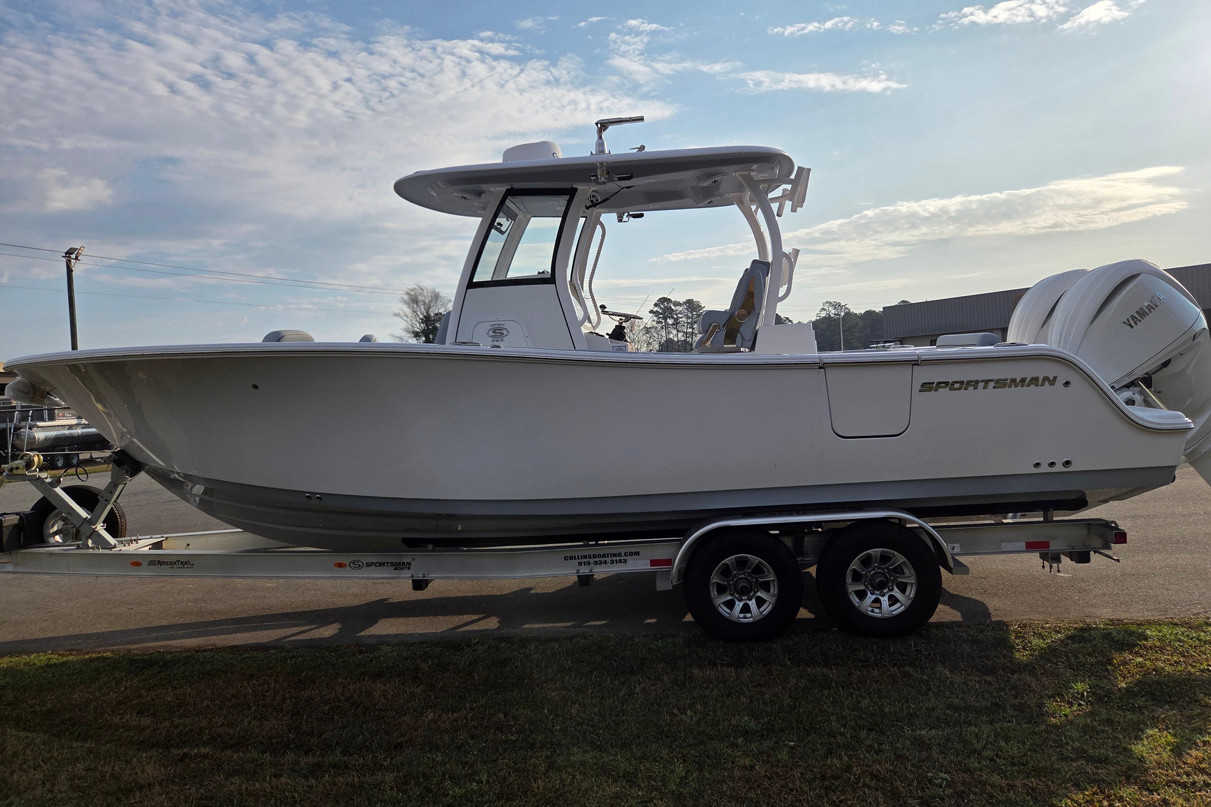 2026 Sportsman Open 282 Center Console boat on trailer under clear sky.