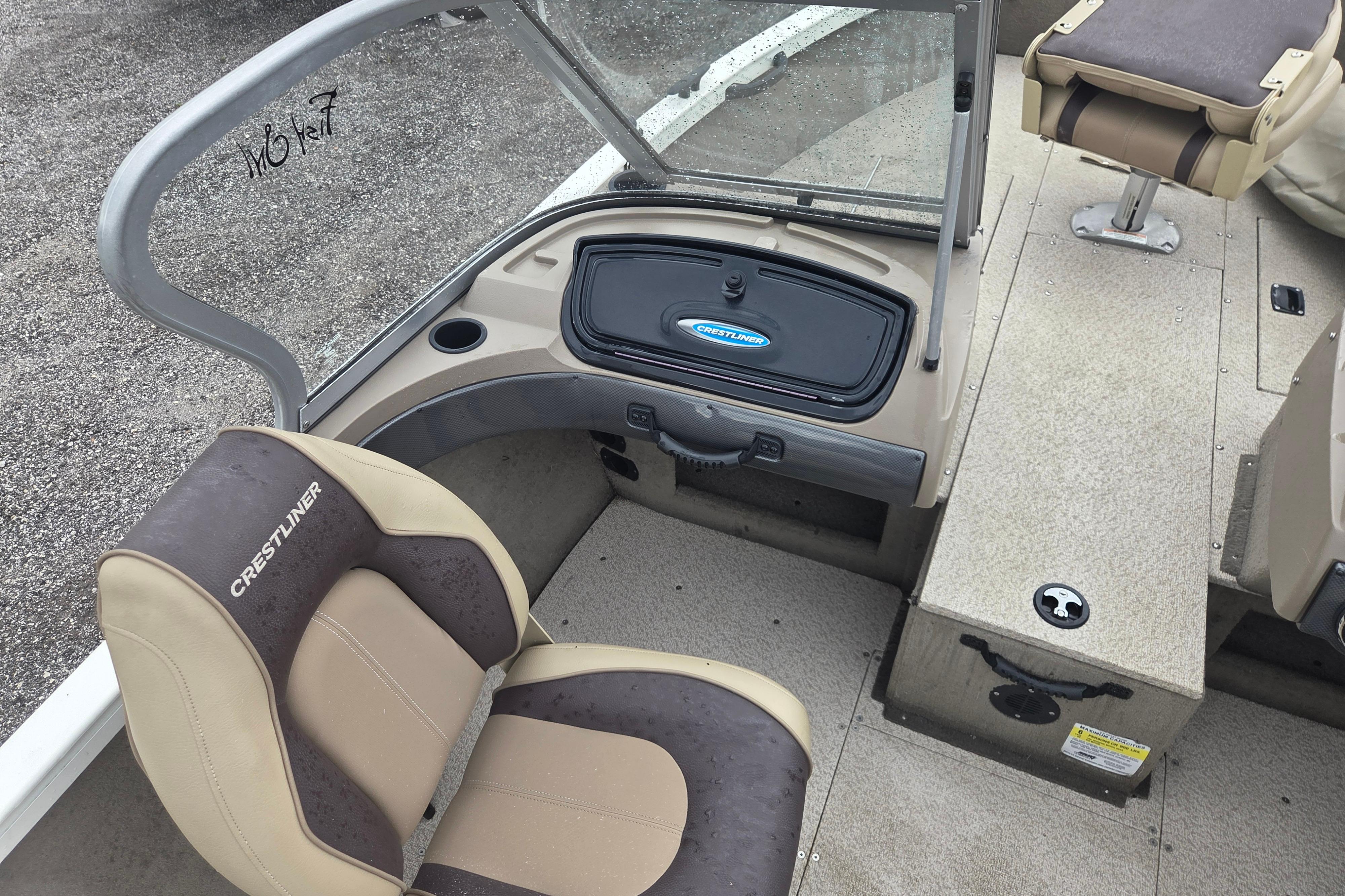 2016 Crestliner 1650 Fish Hawk SC interior with seating and storage compartments.