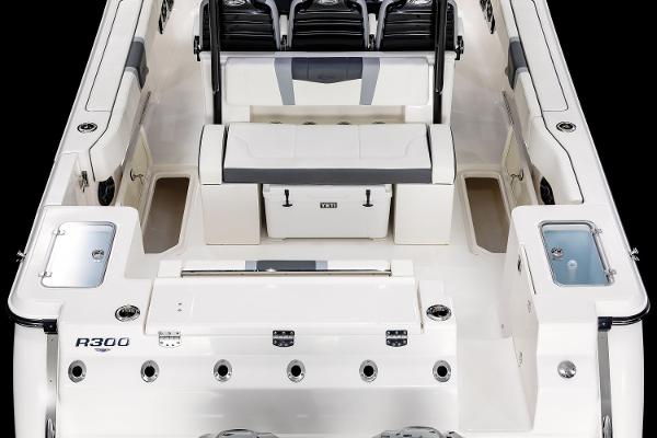 Manufacturer Provided Image: 2025 Robalo R300 Center Console boat interior with seating and storage compartments.