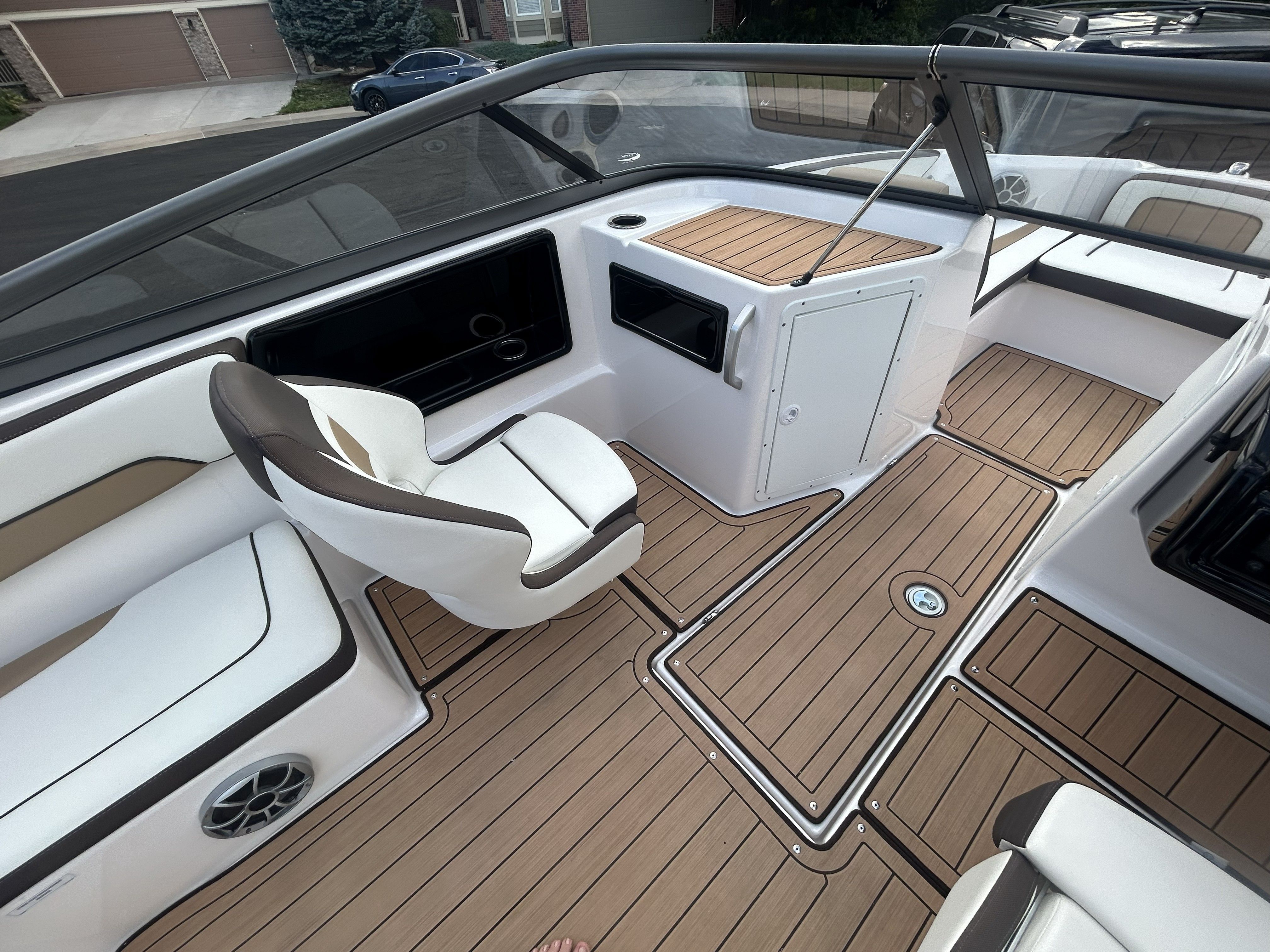 Interior of 2022 Yamaha Boats 195S with sleek seating and wood flooring.