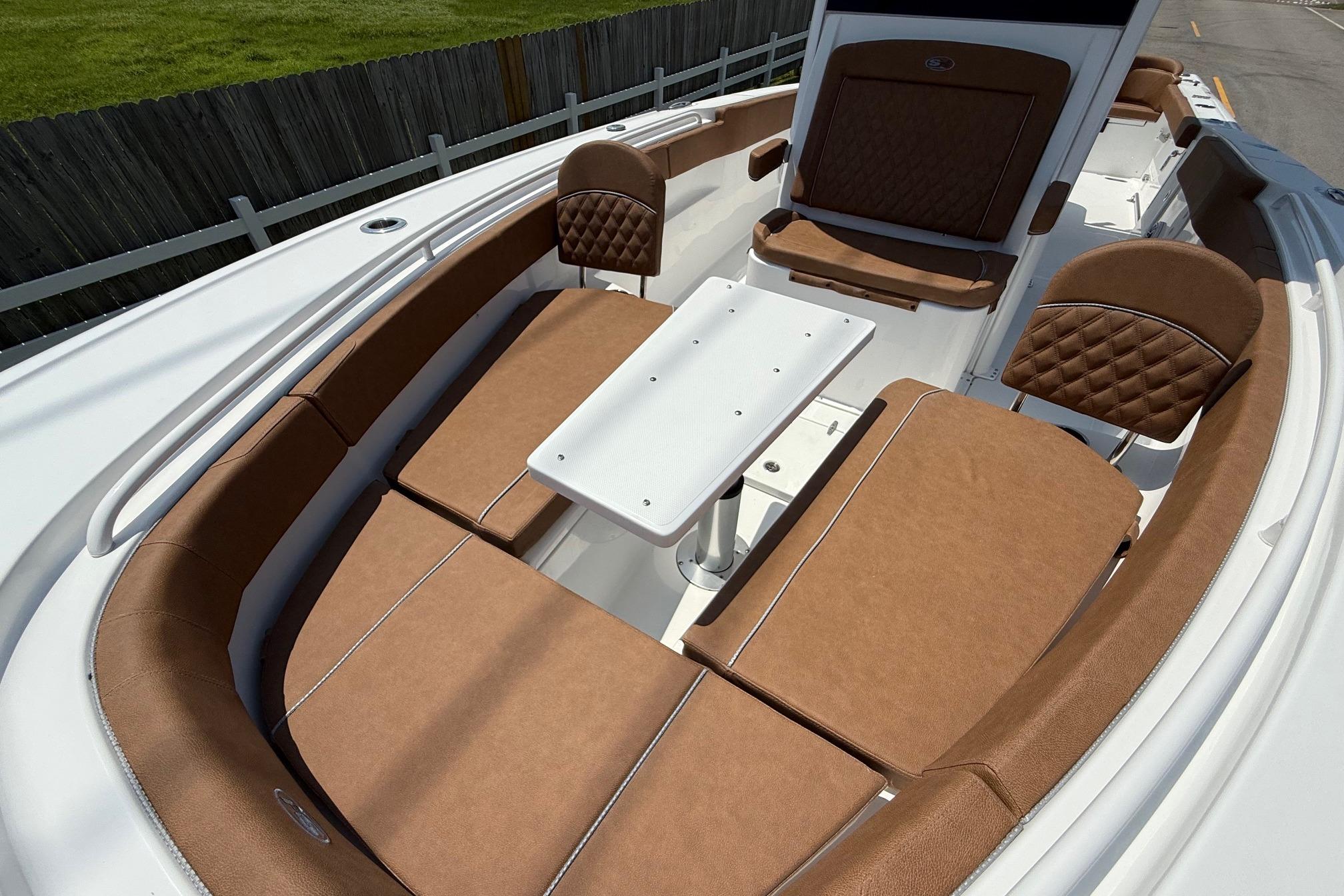 2026 Sea Hunt Ultra 305 SE boat interior with brown seating and white table.