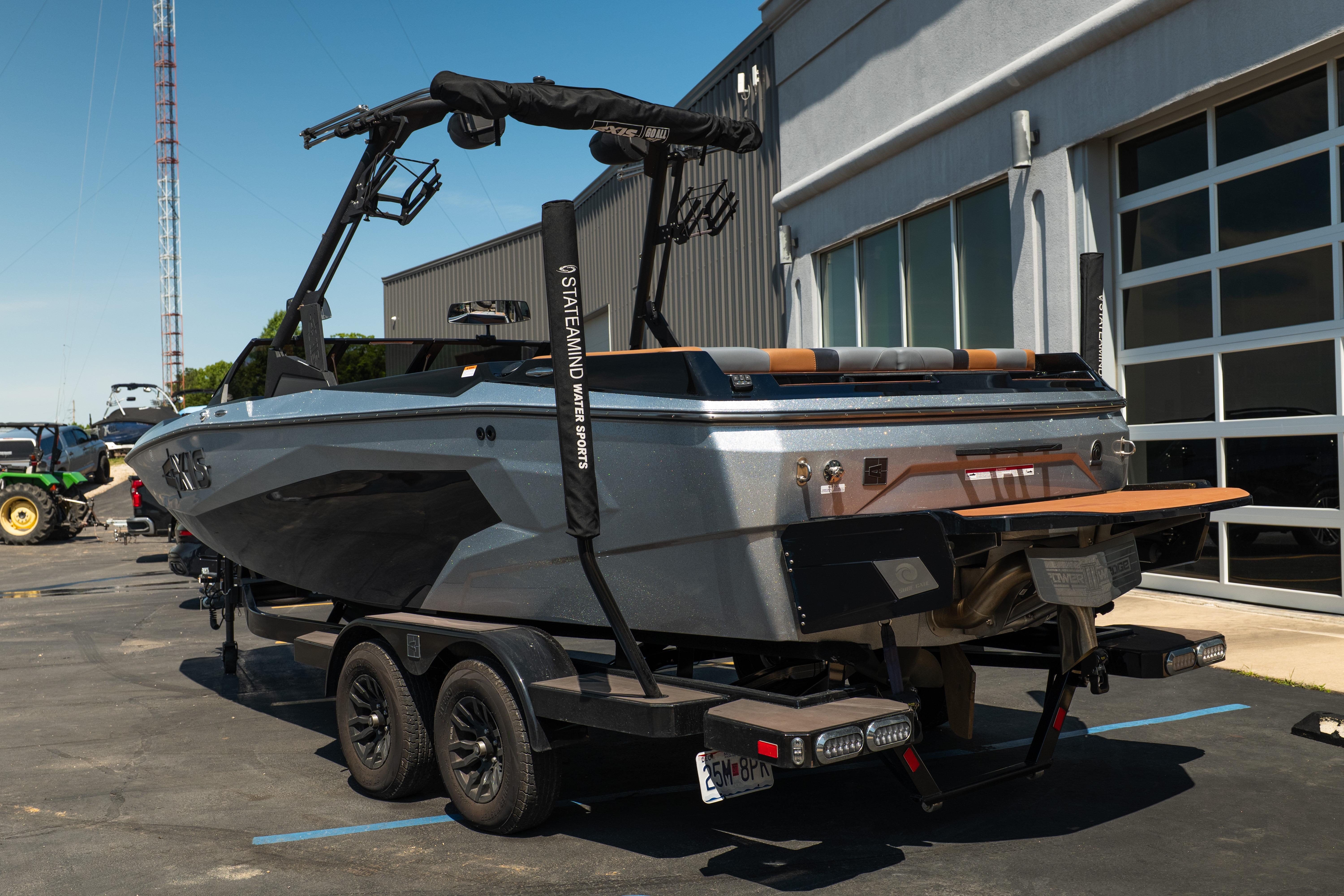 2025 Axis A225 boat on trailer outside a modern building.
