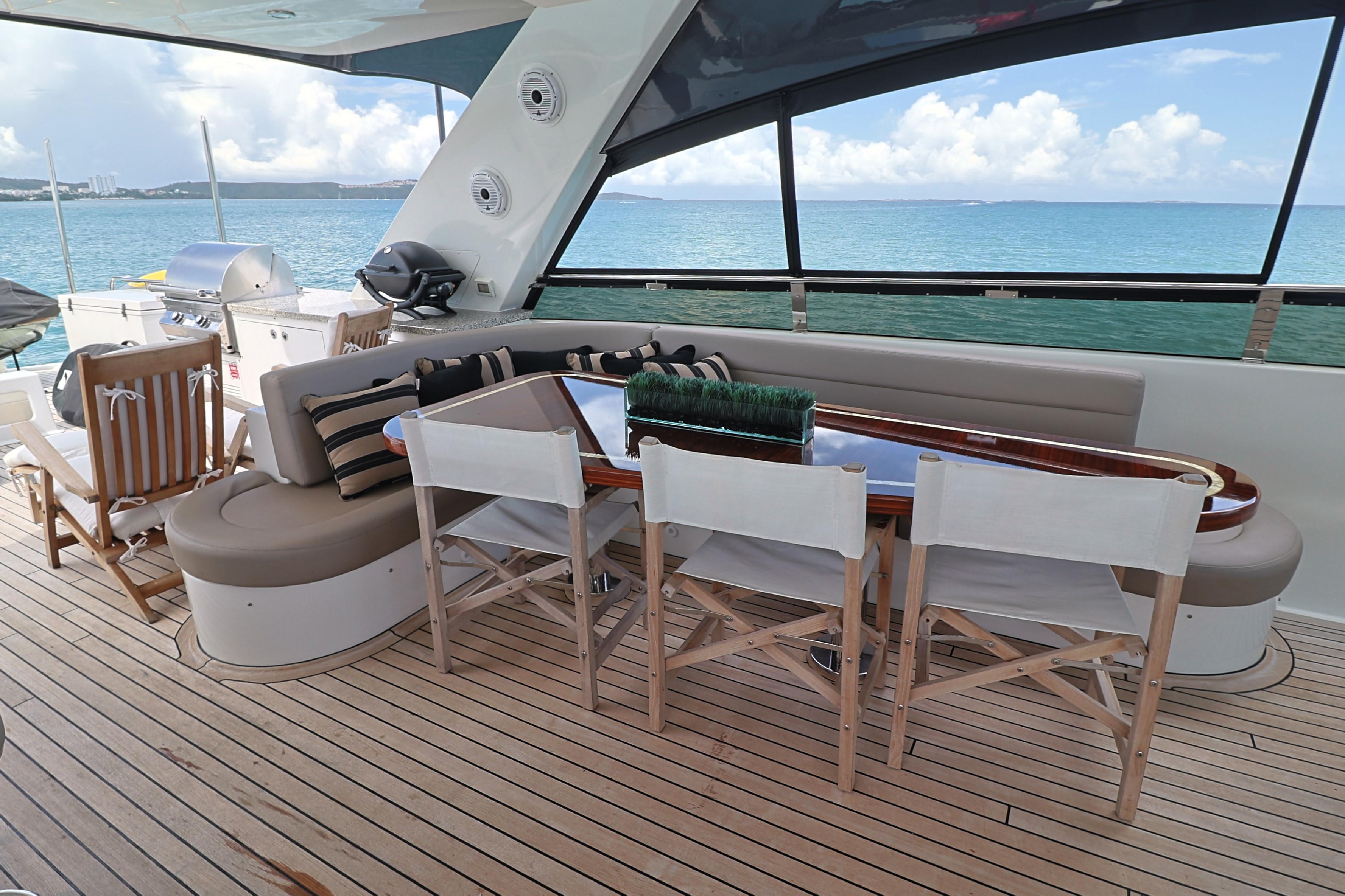 Luxurious 2013 Cheoy Lee Bravo yacht deck with seating, dining area, and ocean view.