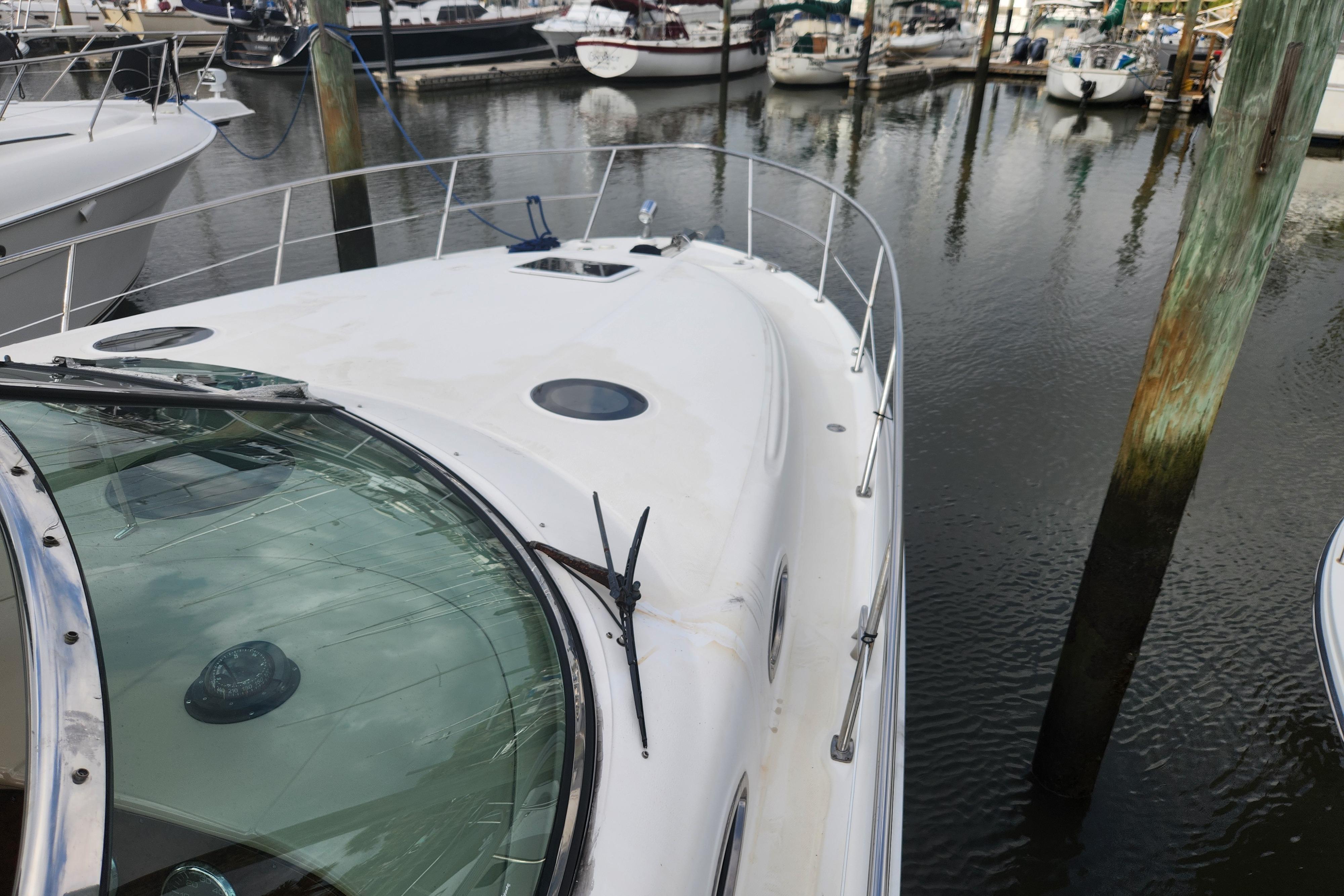 2003 Sea Ray 360 Sundancer docked at marina, showcasing sleek design and spacious deck.