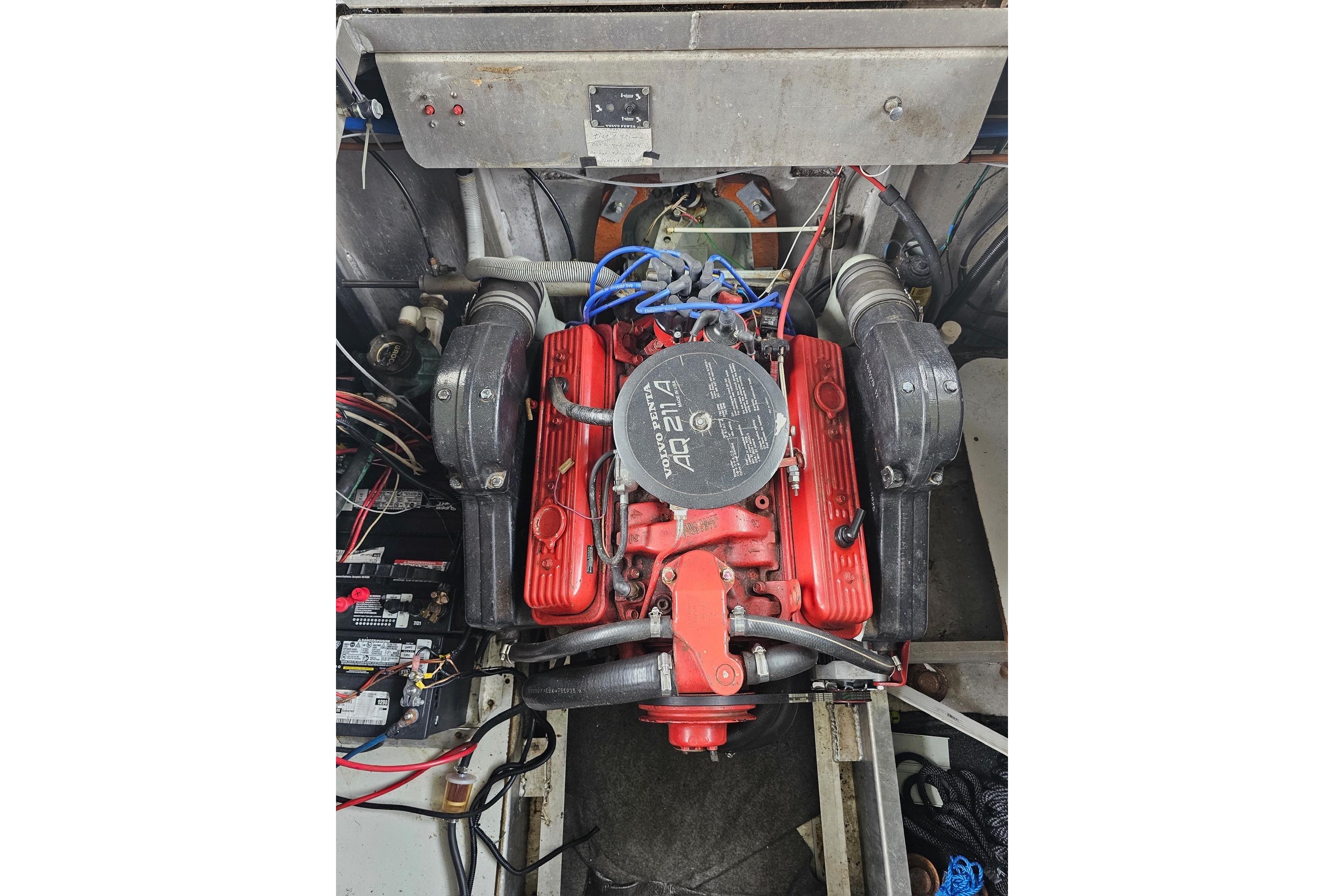 Engine compartment of a 1989 Sumerset 14x62 houseboat with visible wiring and components.