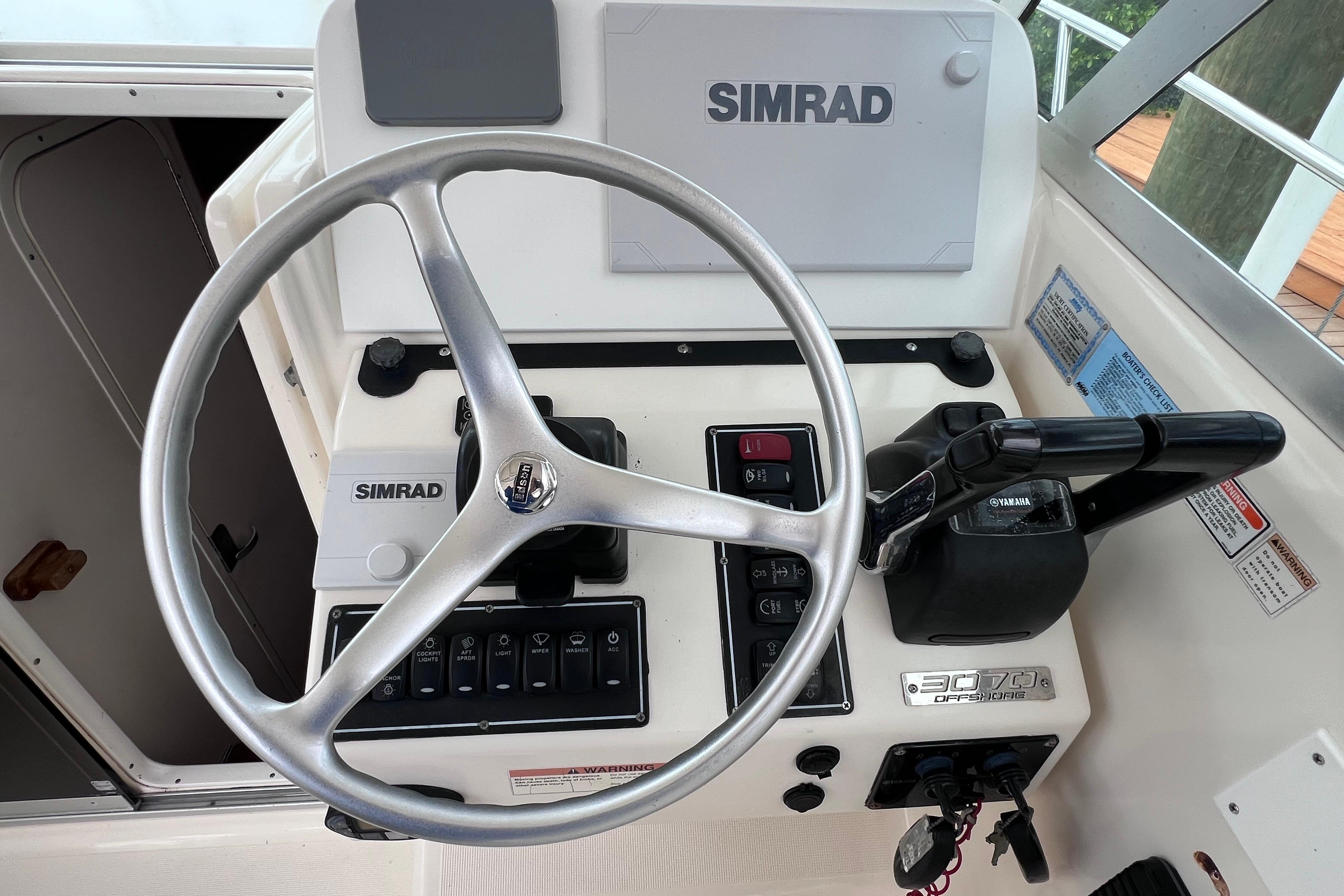 Helm of 2005 Pursuit 3070 Offshore boat with Simrad electronics and Yamaha controls.