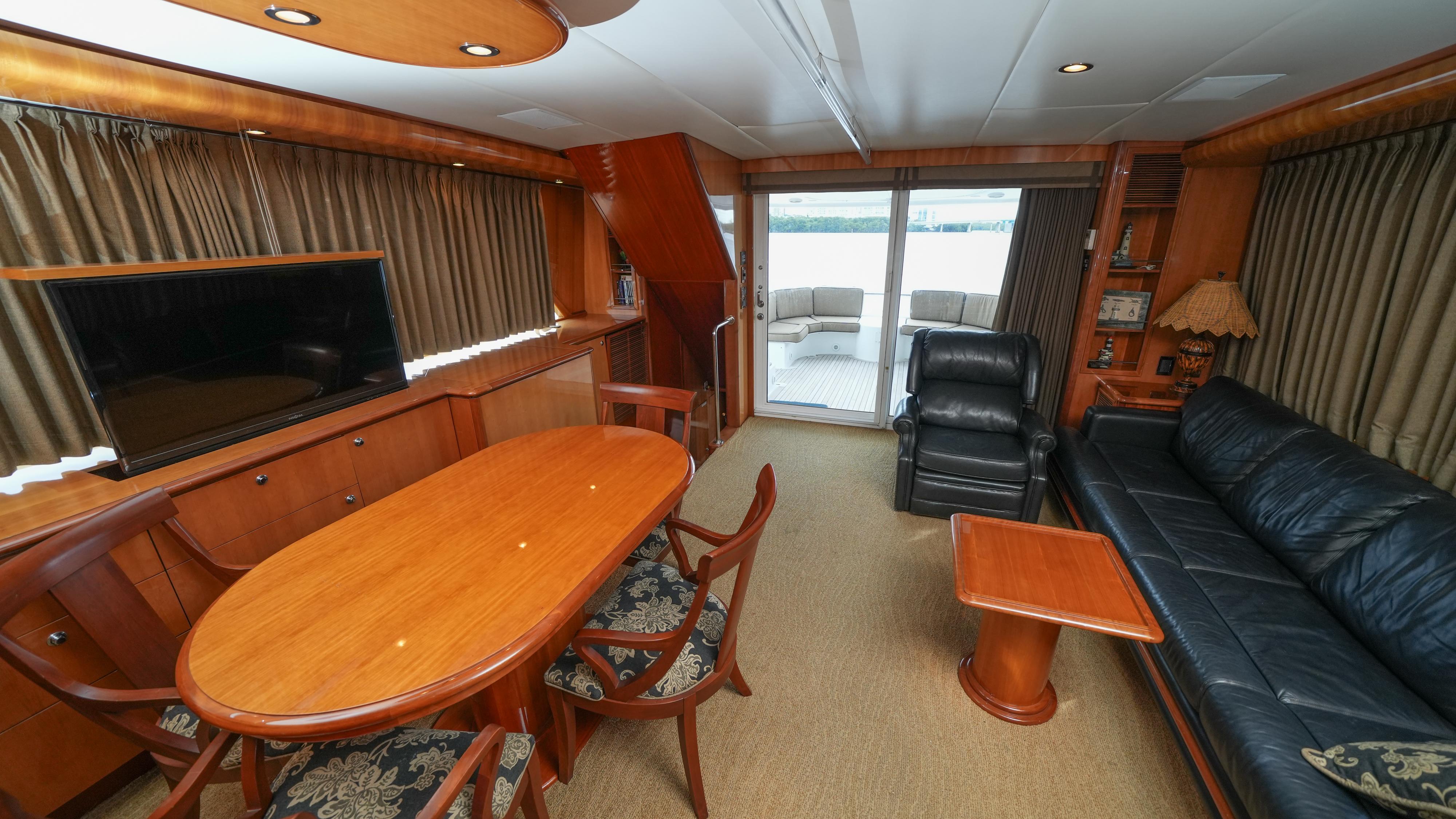 Luxurious interior of 2002 Queenship 70 Baretta yacht with elegant wood furnishings.