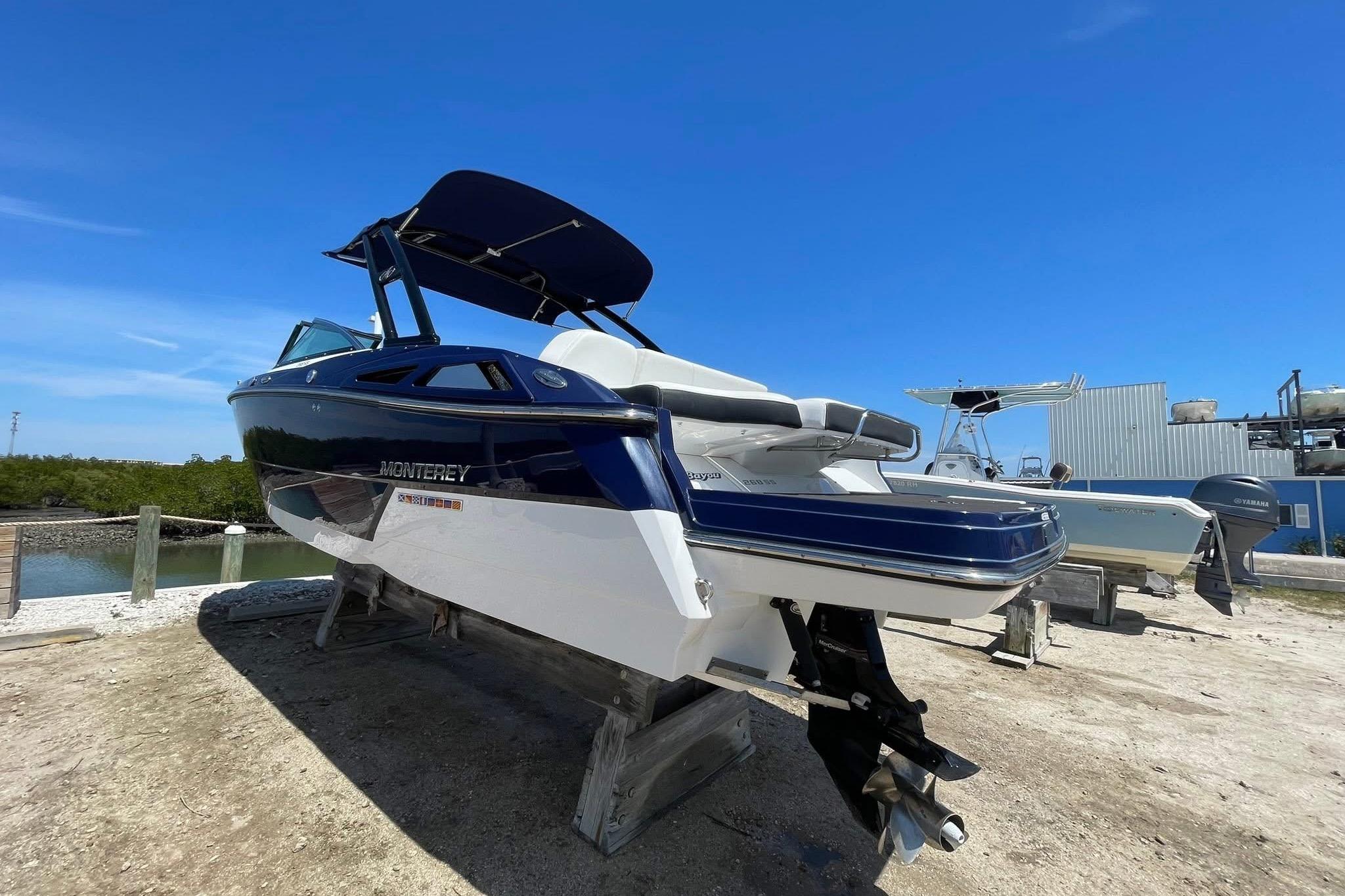 2015 Monterey 268SS Super Sport boat on dry dock under clear blue sky.