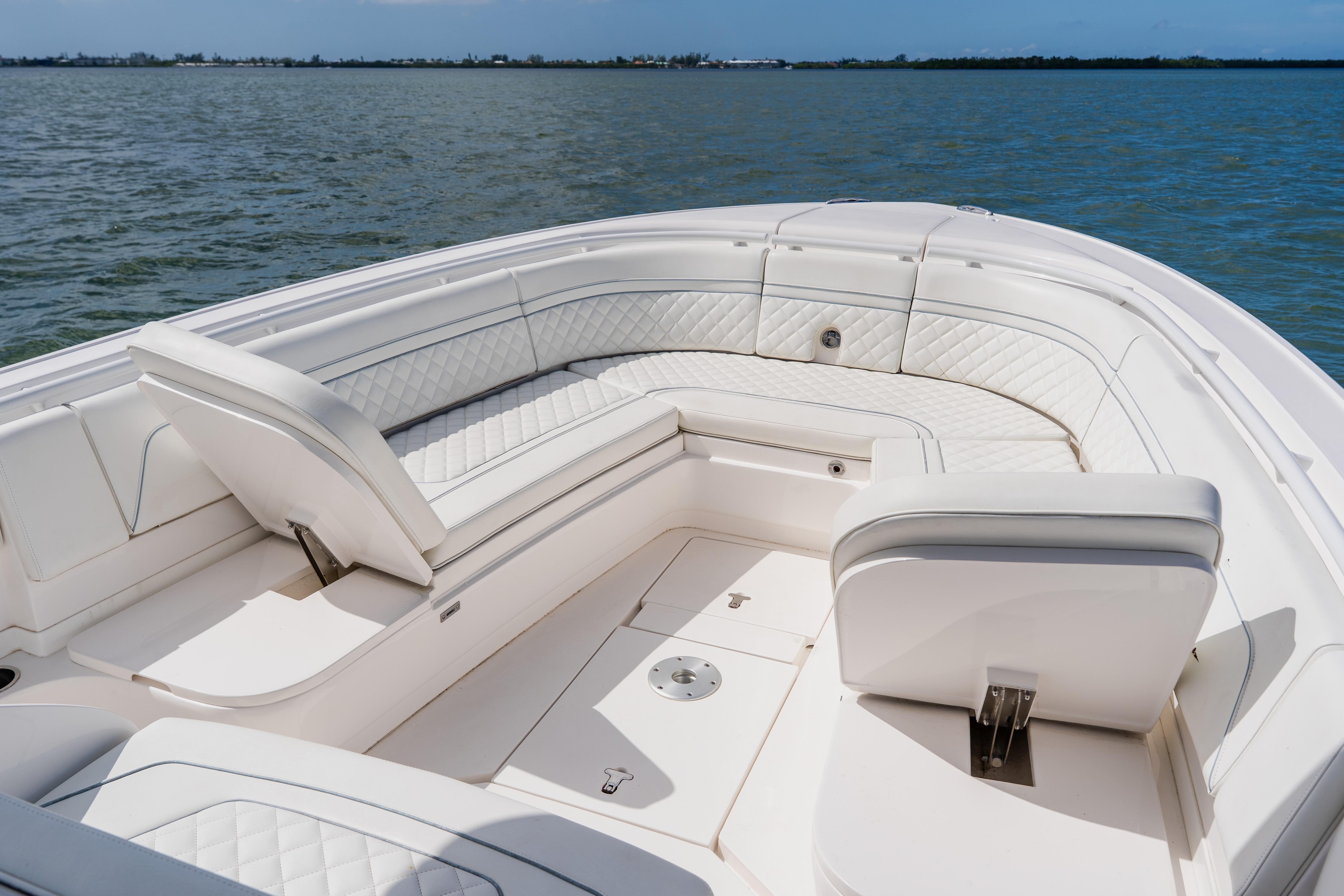 2018 Intrepid 327 Center Console boat with luxurious white seating on open water.