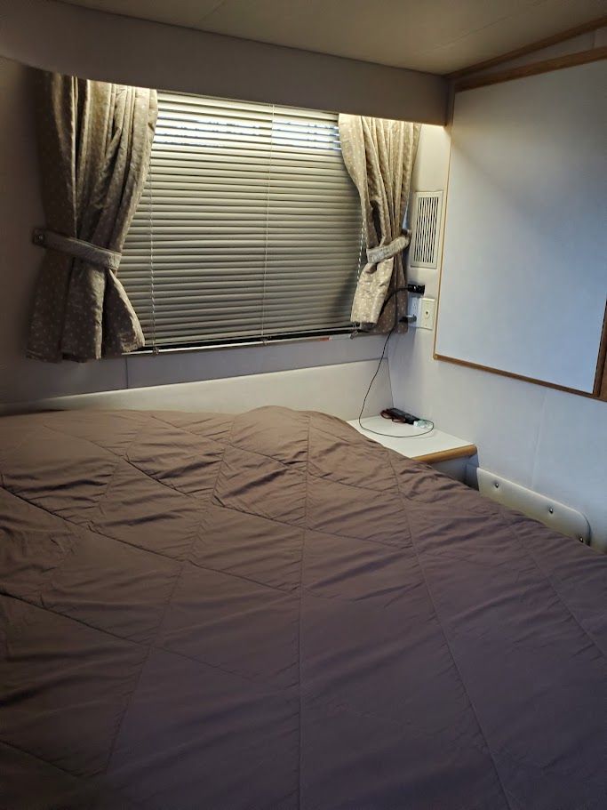 Interior of a 1996 Blue Water Motor Yacht with bed and window.