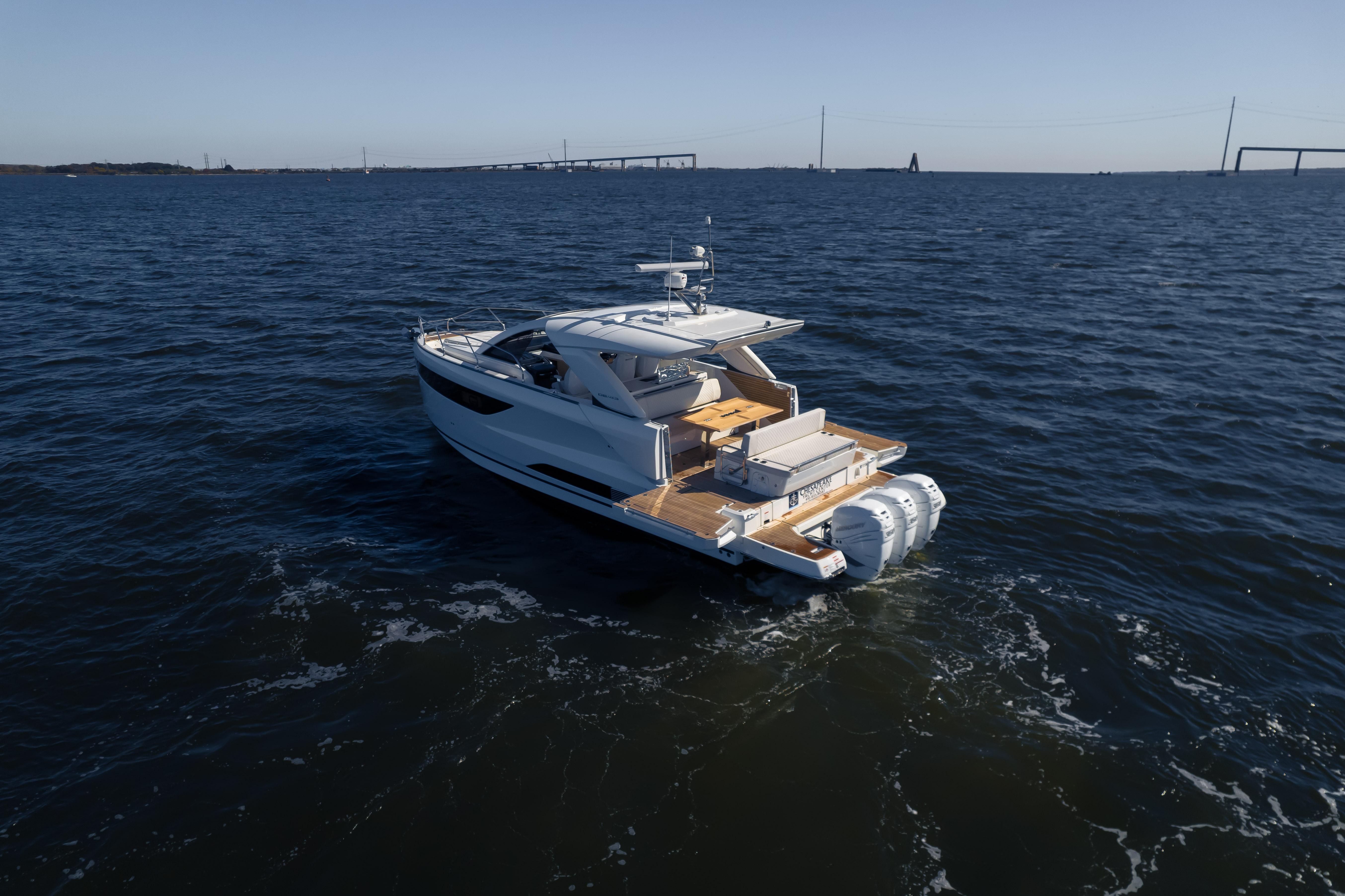 2024 Jeanneau DB/43 OB yacht cruising on open water, showcasing sleek design and powerful engines.