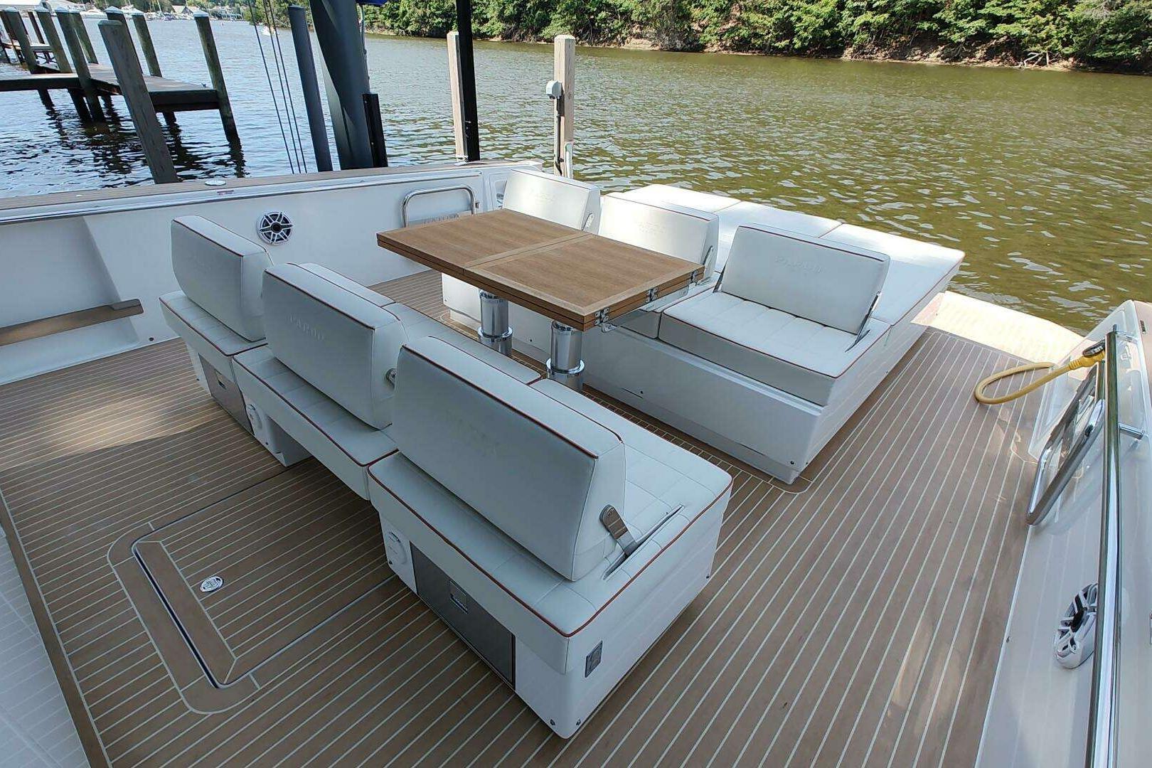 Luxury seating area on 2023 Pardo Yachts P43, featuring elegant wood table and cushioned benches.
