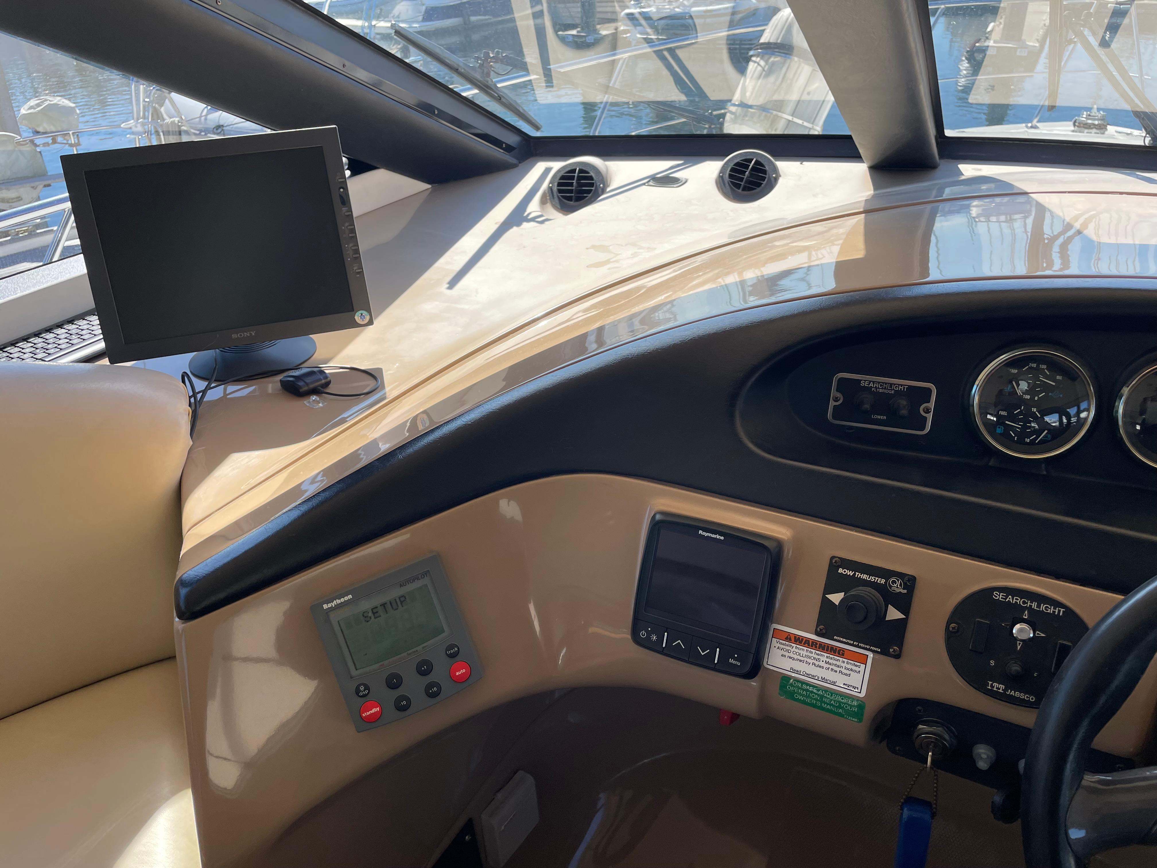 Interior view of 2000 Carver 530 Voyager Pilothouse dashboard with navigation equipment.