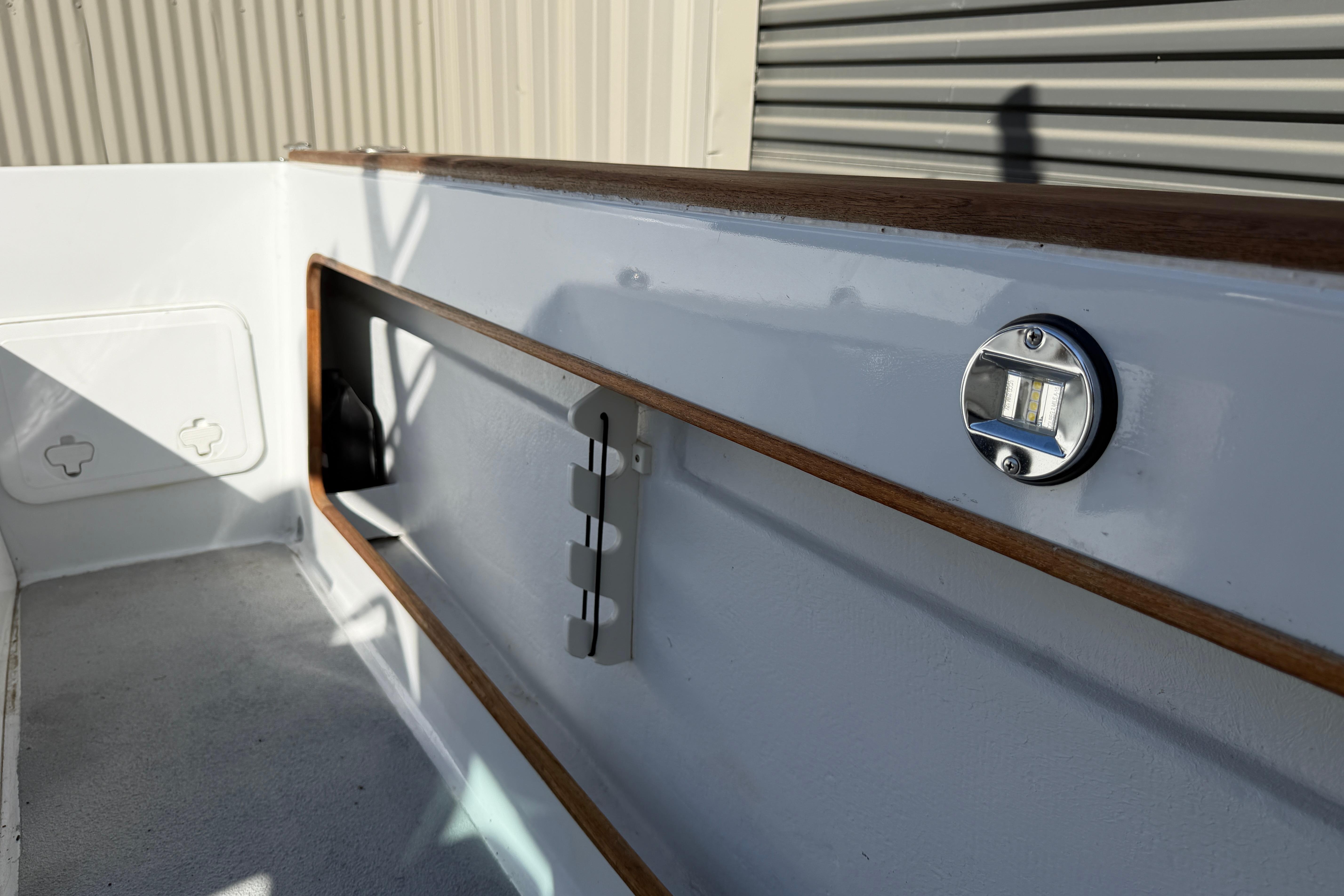 1986 Radon 21 Sport boat interior with wood trim and metal fixtures.