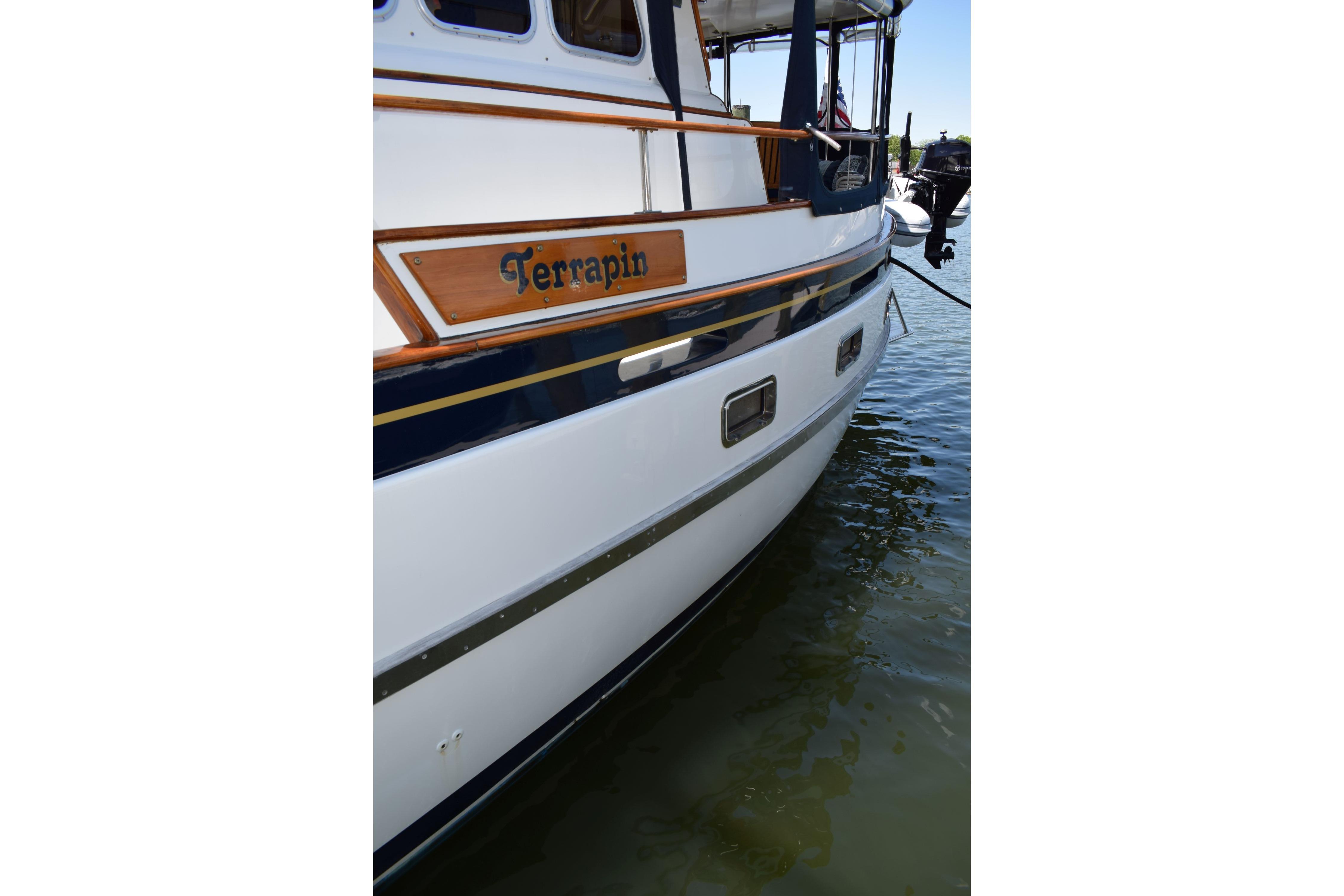 1980 Cheoy Lee 52 Motorsailer "Terrapin" docked, showcasing elegant wooden accents.