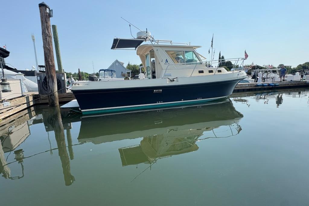 2003 Albin 28 Tournament Express boat docked in a serene marina setting.