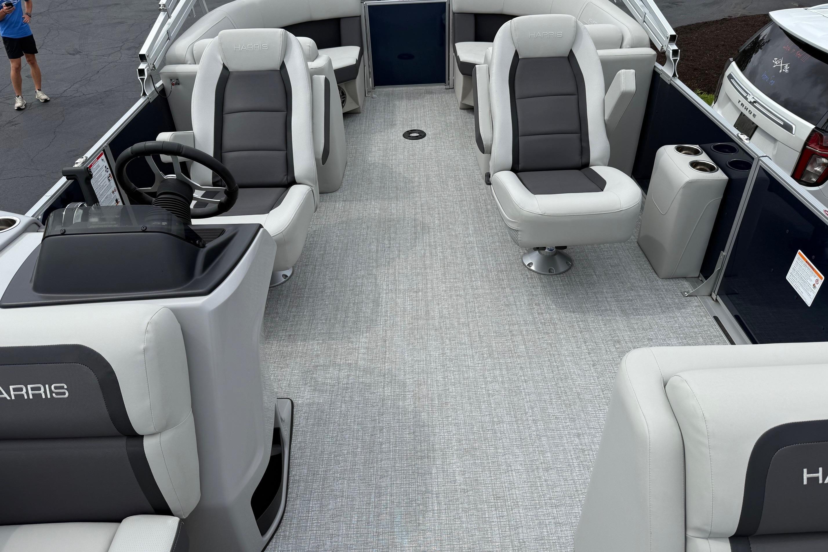 Interior of 2025 Harris Cruiser 230 boat with modern seating and steering console.
