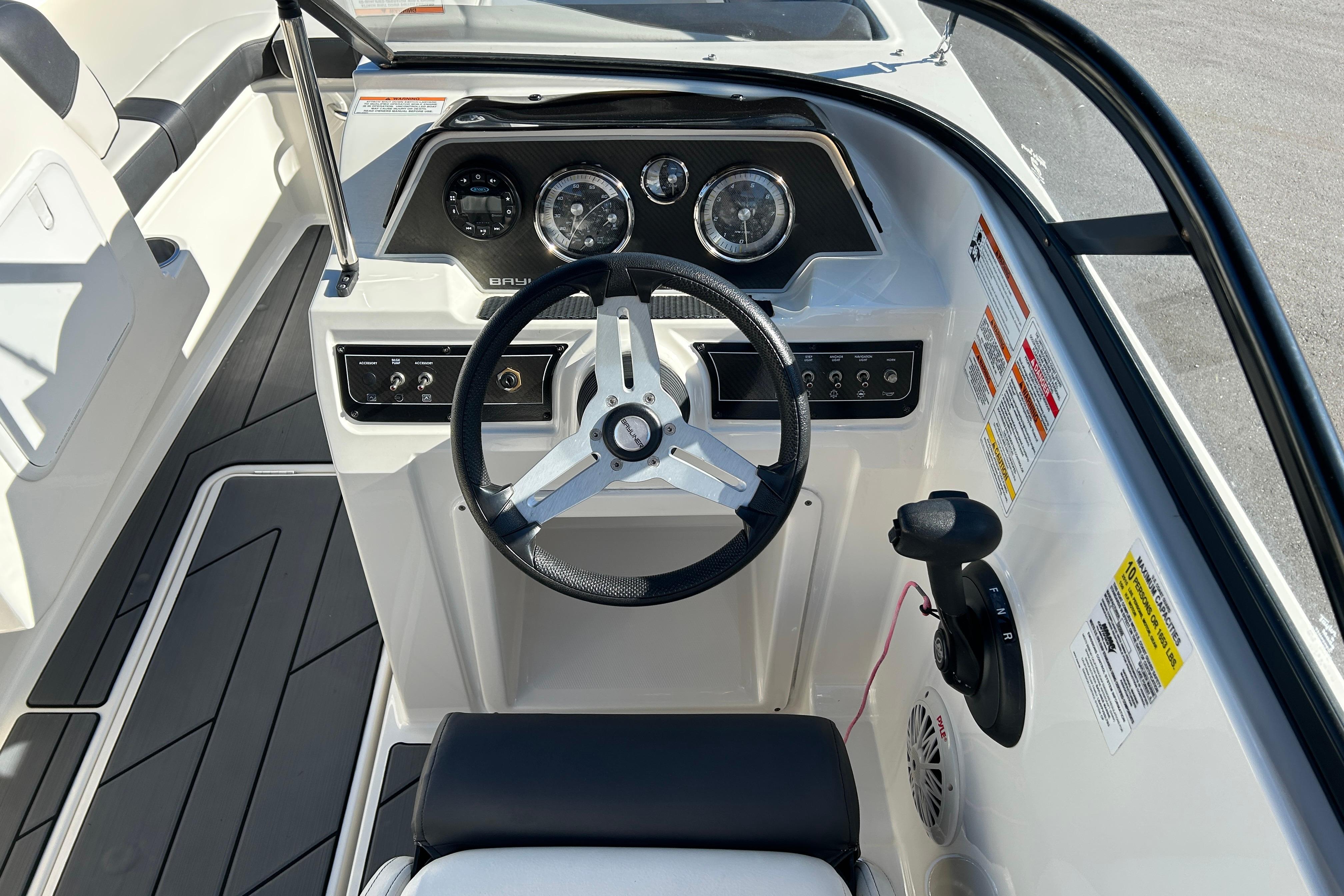 2020 Bayliner DX 2000 boat dashboard with steering wheel and control panel.