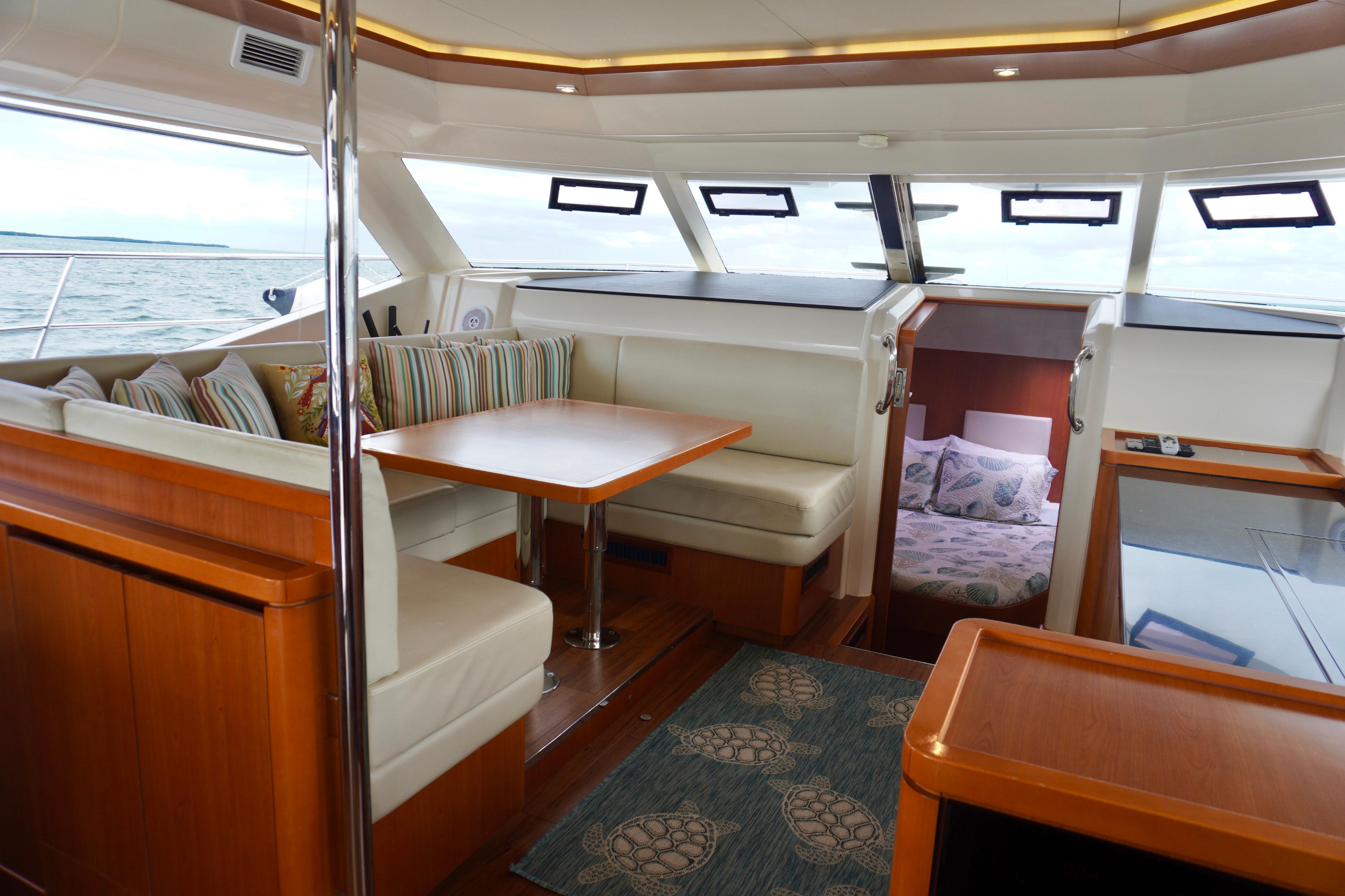 Interior of 2017 Aquila 44 Yacht with dining area and cabin view.