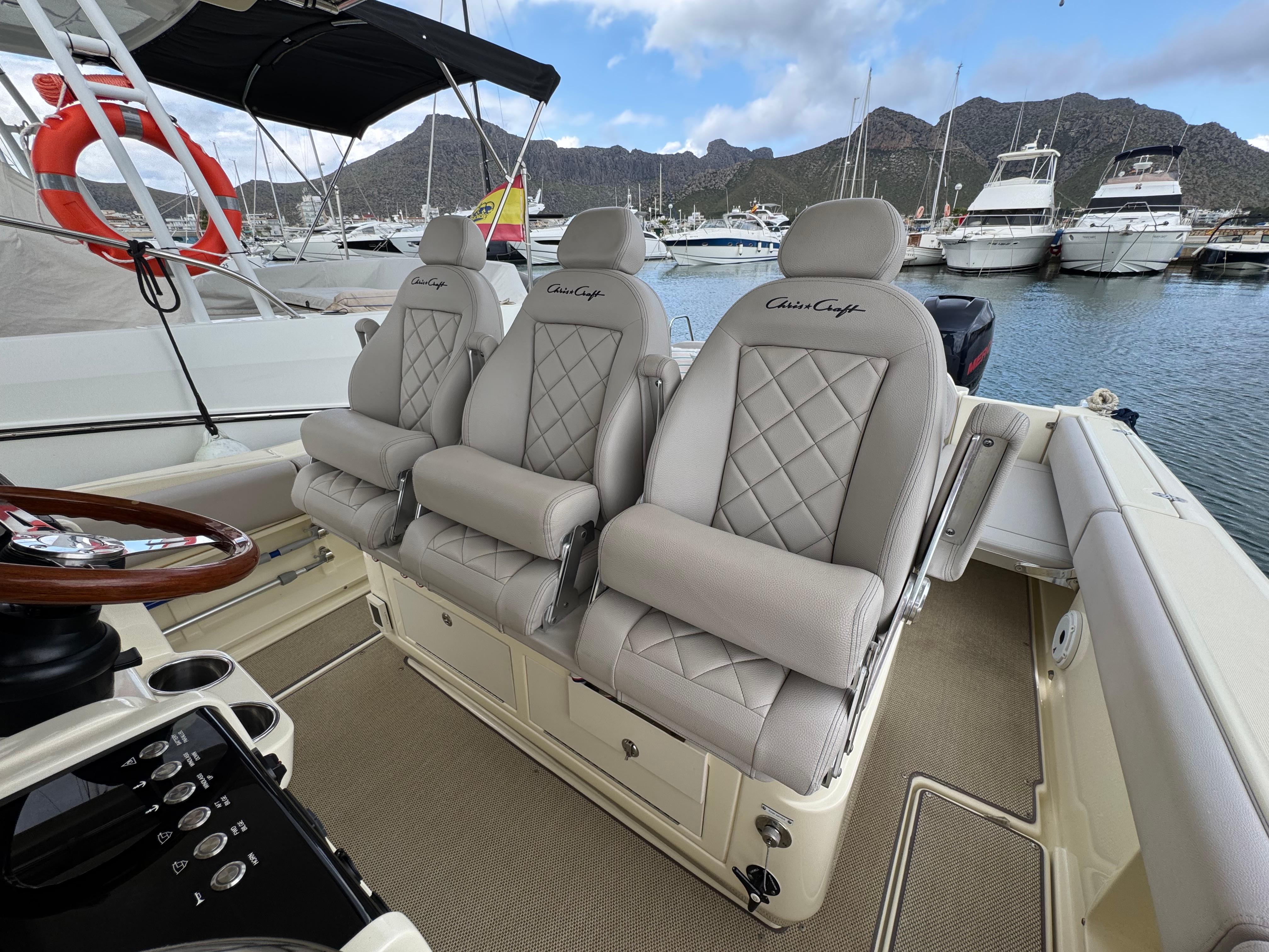 Luxurious seating on 2018 Chris-Craft Catalina 34 boat, docked in marina.