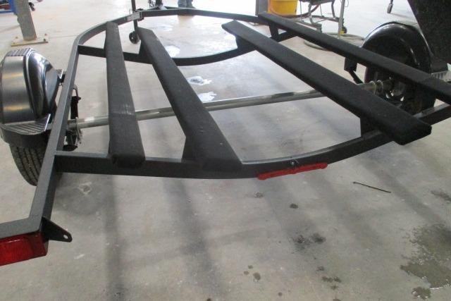 2024 Tahoe T16 boat trailer with black frame and fenders in a workshop setting.