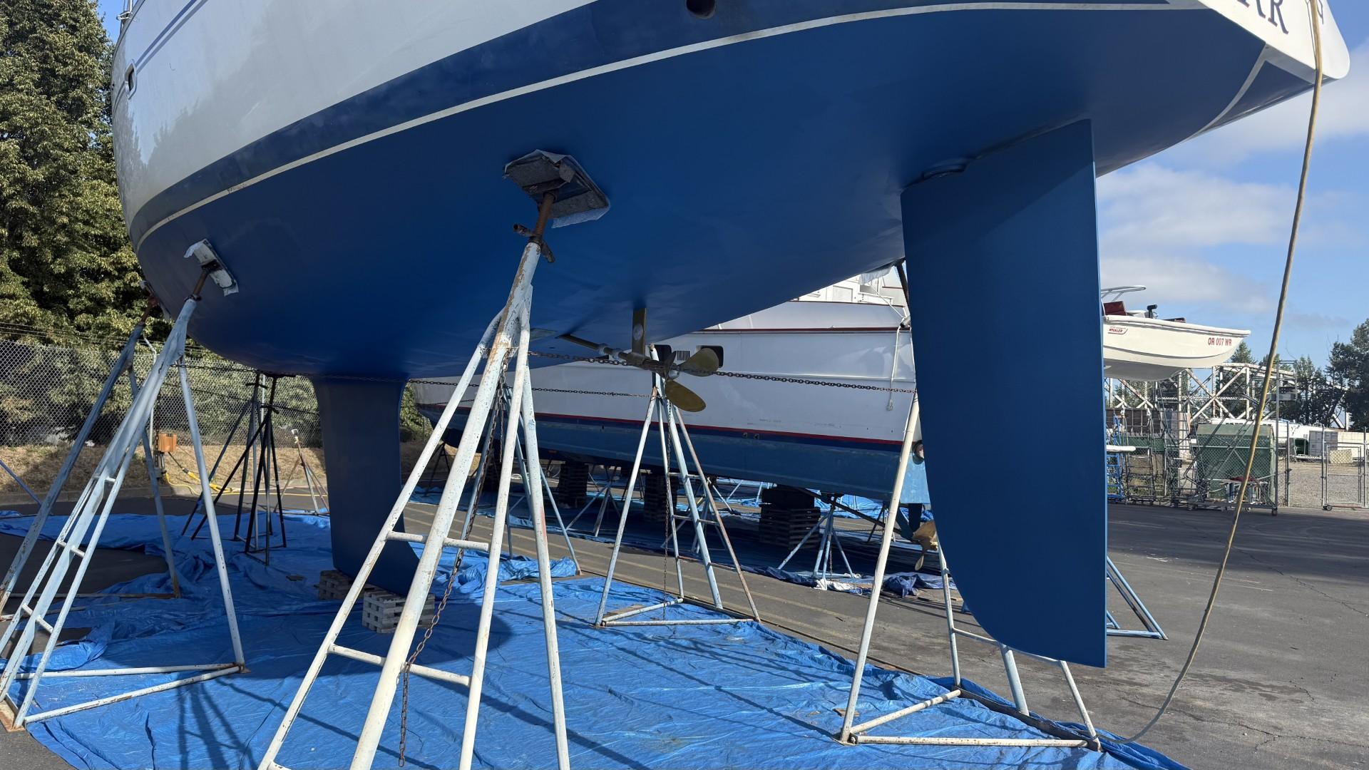 2004 Catalina 470 sailboat on stands, blue hull, outdoor storage.