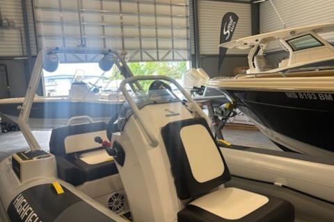 2026 Highfield Velox 420 boat in showroom, featuring sleek design and modern seating.