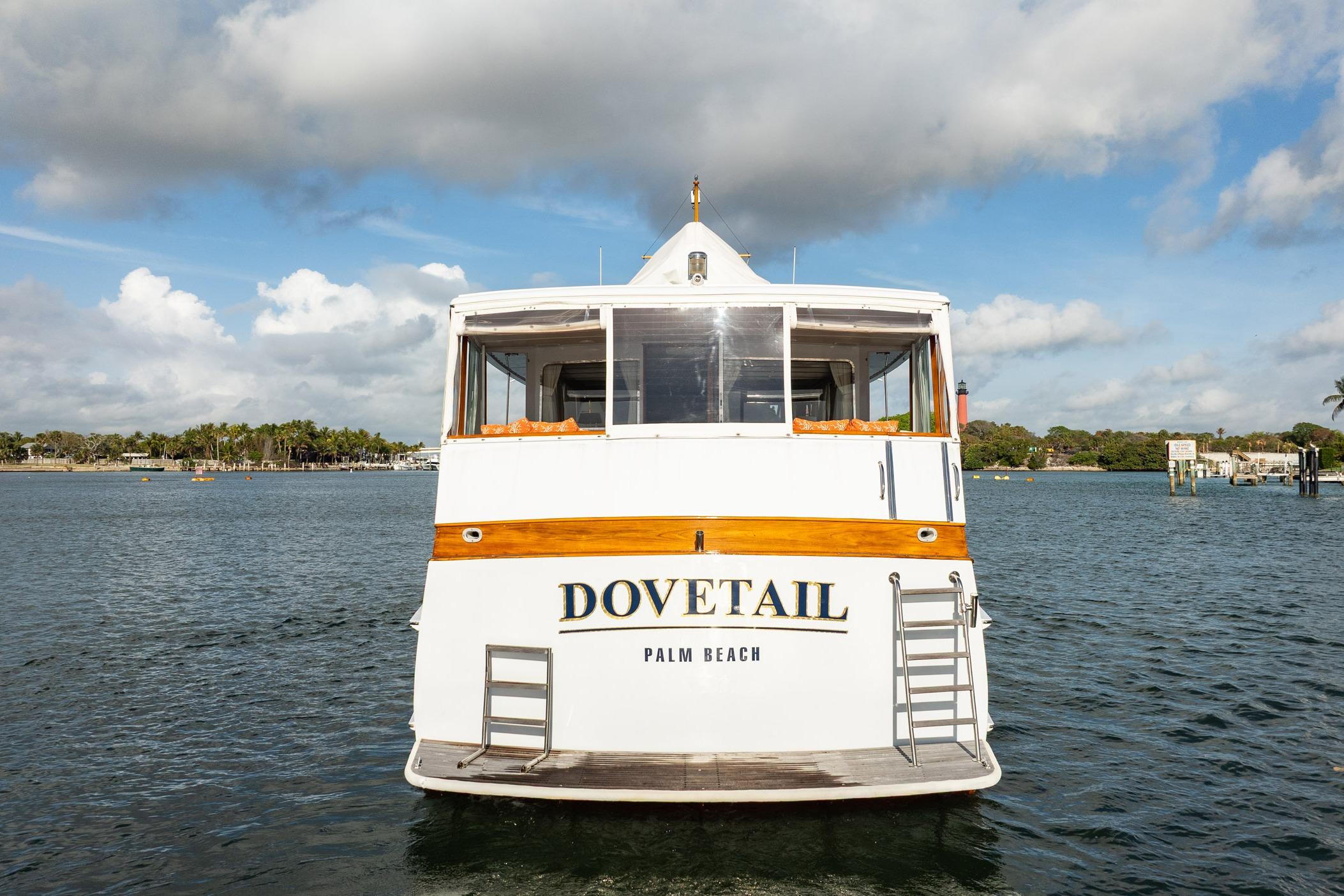 1972 Trumpy 72 Motor Yacht "Dovetail" on water, Palm Beach backdrop.